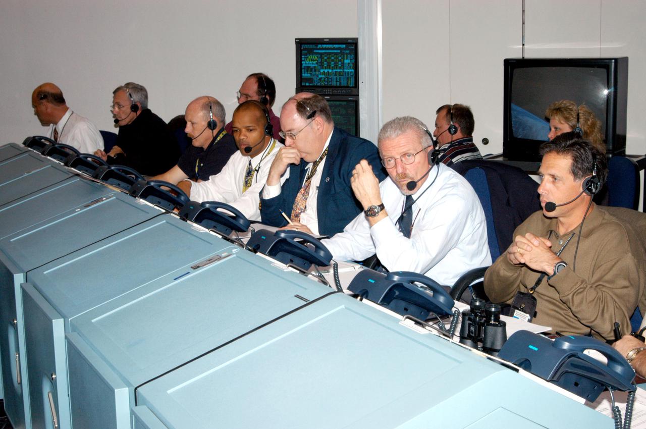 KENNEDY SPACE CENTER, FLA.  -  Space Shuttle Program managers, directors and engineers work the consoles in the Launch Control Center.  They are taking part in an End-to-End (ETE) Mission Management Team (MMT) launch simulation at KSC.  In Firing Room 1 at KSC, Shuttle launch team members put the Shuttle system through an integrated simulation. The control room is set up with software used to simulate flight and ground systems in the launch configuration.  The ETE MMT simulation included L-2 and L-1 day Prelaunch MMT meetings, an external tanking_weather briefing, and a launch countdown.  The ETE transitioned to the Johnson Space Center for the flight portion of the simulation, with the STS-114 crew in a simulator at JSC.  Such simulations are common before a launch to keep the Shuttle launch team sharp and ready for liftoff.