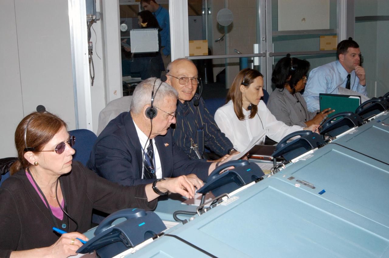 KENNEDY SPACE CENTER, FLA.  -  Space Shuttle Program managers, directors and engineers man the consoles in the Launch Control Center.  They are taking part in an End-to-End (ETE) Mission Management Team (MMT) launch simulation at KSC.  In Firing Room 1 at KSC, Shuttle launch team members put the Shuttle system through an integrated simulation. The control room is set up with software used to simulate flight and ground systems in the launch configuration.  Seated in the center is Bob Sieck, a member of the Stafford-Covey Shuttle Return to Flight Task Group; at his left is Forrest McCartney, former Kennedy Space Center director.  Sieck served as launch director and director of Shuttle Processing in the 80s and 90s.  The ETE MMT simulation included L-2 and L-1 day Prelaunch MMT meetings, an external tanking_weather briefing, and a launch countdown.  The ETE transitioned to the Johnson Space Center for the flight portion of the simulation, with the STS-114 crew in a simulator at JSC.  Such simulations are common before a launch to keep the Shuttle launch team sharp and ready for liftoff.