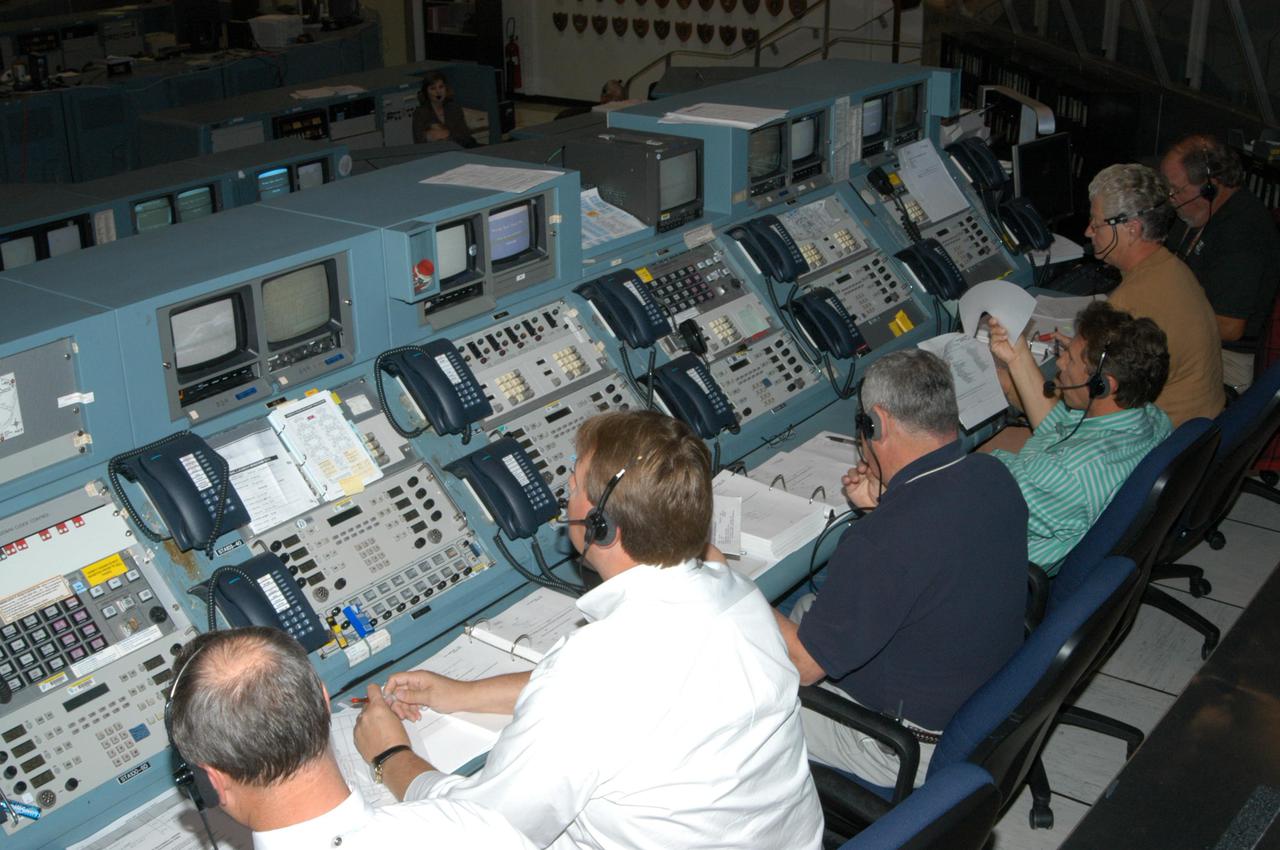 KENNEDY SPACE CENTER, FLA.  -  Space Shuttle Program managers, directors and engineers work the consoles in the Launch Control Center.  They are taking part in an End-to-End (ETE) Mission Management Team (MMT) launch simulation at KSC.  In Firing Room 1 at KSC, Shuttle launch team members put the Shuttle system through an integrated simulation. The control room is set up with software used to simulate flight and ground systems in the launch configuration.  The ETE MMT simulation included L-2 and L-1 day Prelaunch MMT meetings, an external tanking_weather briefing, and a launch countdown.  The ETE transitioned to the Johnson Space Center for the flight portion of the simulation, with the STS-114 crew in a simulator at JSC.  Such simulations are common before a launch to keep the Shuttle launch team sharp and ready for liftoff.