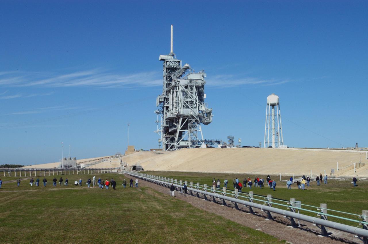 KENNEDY SPACE CENTER, FLA.  -  Preparing for Return to Flight, workers at KSC walk the grounds around Launch Pad 39B looking for Foreign Object Debris, or FOD.  The pad was recently refurbished and any possible debris left behind must be removed from the area prior to launch.  Foreign objects that are alien to flight systems may cause material damage or may make the system or equipment inoperable, unsafe or less efficient. The Return to Flight mission STS-114 aboard Space Shuttle Discovery will carry supplies and equipment to the International Space Station.  Discovery is scheduled for launch in a window from May 15 to June 3.