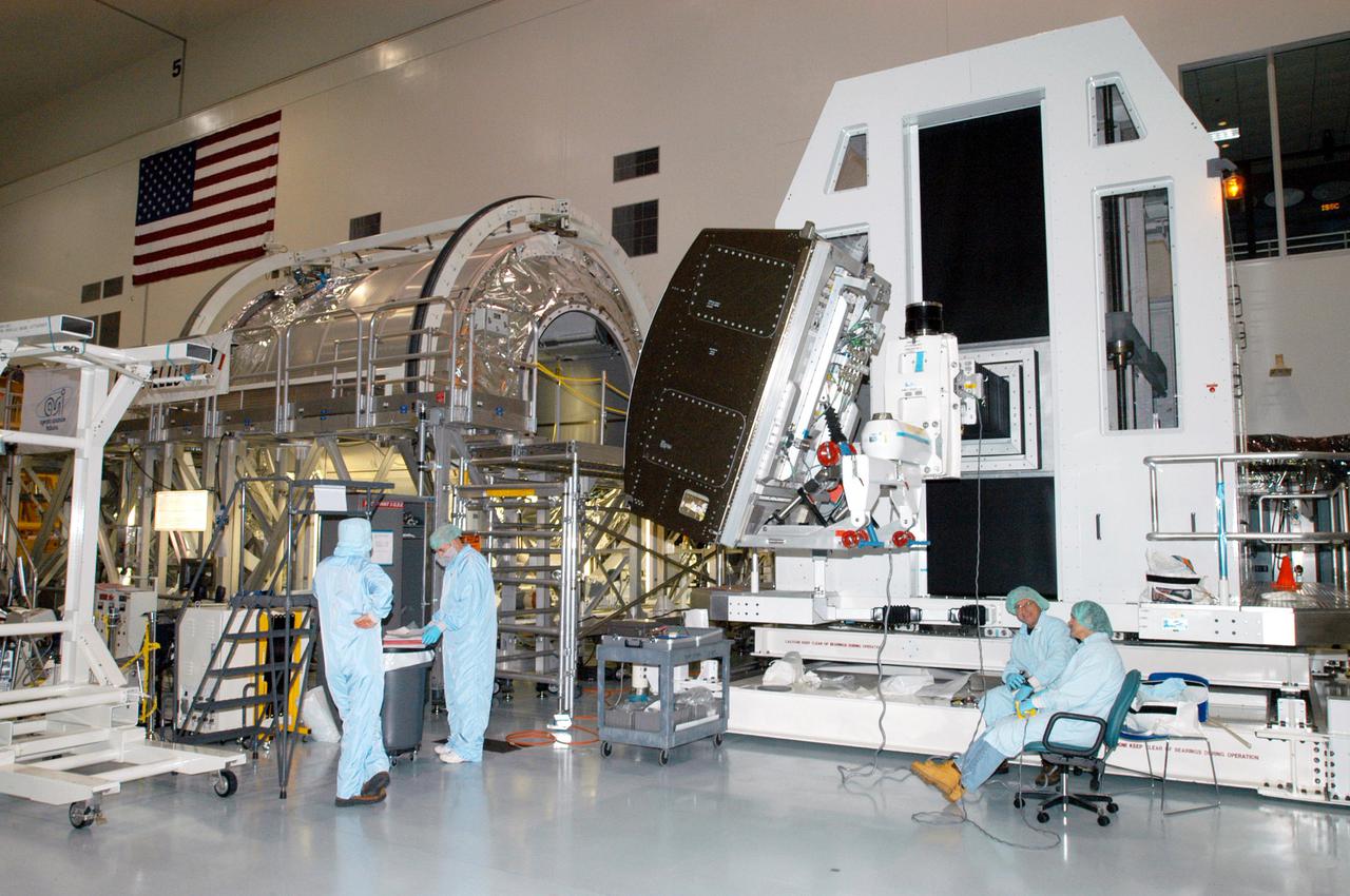 KENNEDY SPACE CENTER, FLA. - In the Space Station Processing Facility, workers prepare to attach the Human Research Facility-2 (HRF-2) science rack onto the Rack Insertion Device. HRF-2 will be installed into the Multi-Purpose Logistics Module Raffaello (at left) for flight on Space Shuttle Discovery’s Return to Flight mission, STS-114. The HRF-2 will deliver additional biomedical instrumentation and research capability to the International Space Station. HRF-1, installed on the U.S. Lab since May 2001, contains an ultrasound unit and gas analyzer. Both racks provide structural, power, thermal, command and data handling, and communication and tracking interfaces between the HRF biomedical instrumentation and the U.S. Laboratory, Destiny. NASA Kennedy Space Center and their prime contractor responsible for ISS element processing, The Boeing Company, prepared the rack for installation. The HRF Project is managed by NASA Johnson Space Center and implemented through contract with Lockheed Martin, Houston, Texas.