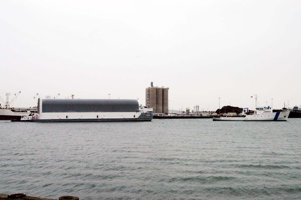 KENNEDY SPACE CENTER, FLA. - The barge carrying a newly redesigned External Tank (ET-121) designated for use on Return to Flight mission STS-121 approaches Port Canaveral after its 900-mile journey at sea from the Michoud Assembly Facility in New Orleans. It is being towed by NASA’s Solid Rocket Booster Retrieval Ship Freedom Star. At Port Canaveral, the barge will be hooked up to tugs for the last part of the journey to the Launch Complex 39 Area Turn Basin at NASA’s Kennedy Space Center. It will then be offloaded and transported to the Vehicle Assembly Building.