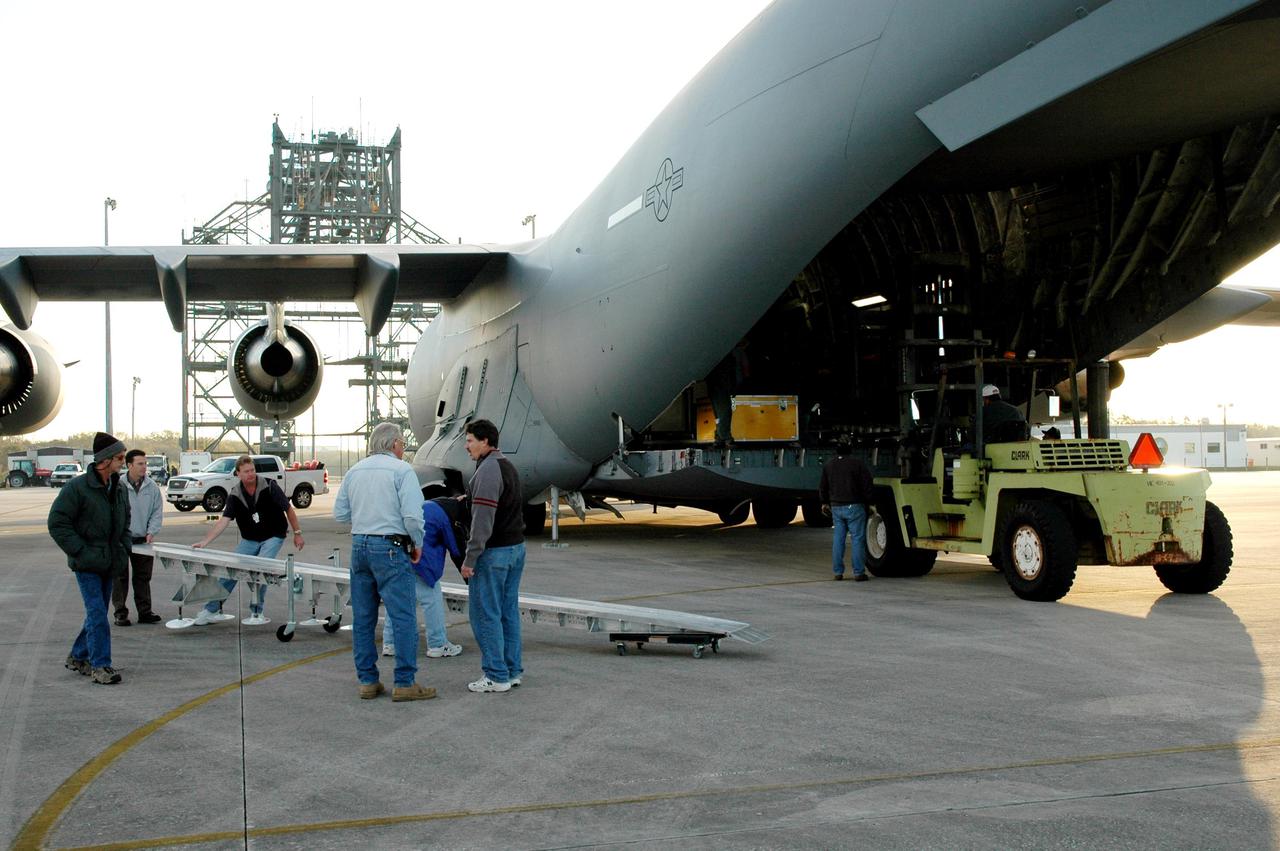KENNEDY SPACE CENTER, FLA. - At KSC’s Shuttle Landing Facility, workers get ready to offload the latest Geostationary Operational Environmental Satellite (GOES) developed by NASA for the National Oceanic and Atmospheric Administration (NOAA) from a C17 military cargo aircraft. Called GOES-N, the satellite is targeted to launch May 4 onboard a Boeing expendable launch vehicle Delta IV (4,2). Once in orbit GOES-N will be designated GOES-13 and will complete checkout and be placed in on-orbit storage as a replacement for an older GOES satellite. After arriving, the satellite was transported to Astrotech in Titusville, Fla., where final testing of the imaging system, instrumentation, communications and power systems will be performed over the next two months by Boeing Satellite Systems.