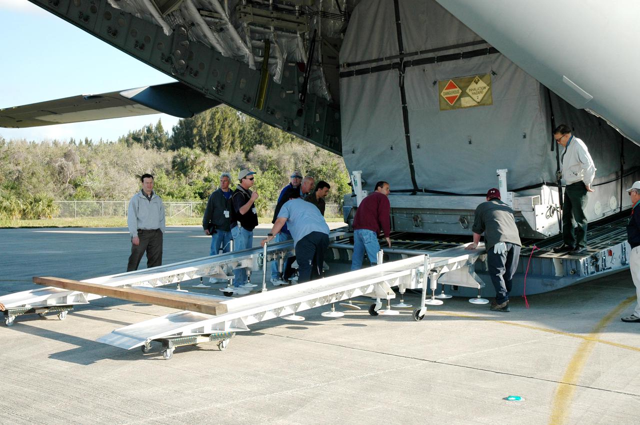KENNEDY SPACE CENTER, FLA. - At KSC’s Shuttle Landing Facility, workers offload the latest Geostationary Operational Environmental Satellite (GOES) developed by NASA for the National Oceanic and Atmospheric Administration (NOAA) from the C17 military cargo aircraft that delivered it. Called GOES-N, the satellite is targeted to launch May 4 onboard a Boeing expendable launch vehicle Delta IV (4,2). Once in orbit GOES-N will be designated GOES-13 and will complete checkout and be placed in on-orbit storage as a replacement for an older GOES satellite. After arriving, the satellite was transported to Astrotech in Titusville, Fla., where final testing of the imaging system, instrumentation, communications and power systems will be performed over the next two months by Boeing Satellite Systems.