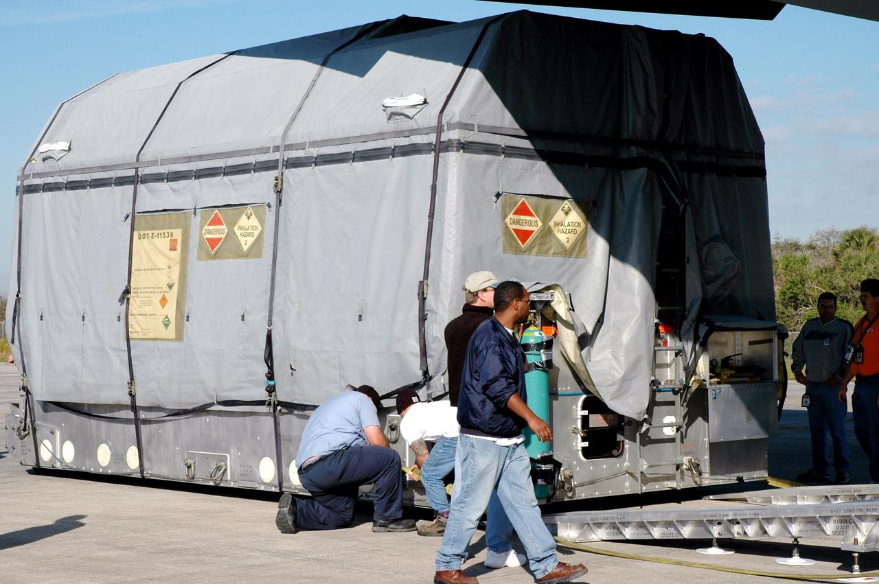 KENNEDY SPACE CENTER, FLA. - At KSC’s Shuttle Landing Facility, workers offload the latest Geostationary Operational Environmental Satellite (GOES) developed by NASA for the National Oceanic and Atmospheric Administration (NOAA) from the C17 military cargo aircraft that delivered it. Called GOES-N, the satellite is targeted to launch May 4 onboard a Boeing expendable launch vehicle Delta IV (4,2). Once in orbit GOES-N will be designated GOES-13 and will complete checkout and be placed in on-orbit storage as a replacement for an older GOES satellite. After arriving, the satellite was transported to Astrotech in Titusville, Fla., where final testing of the imaging system, instrumentation, communications and power systems will be performed over the next two months by Boeing Satellite Systems.