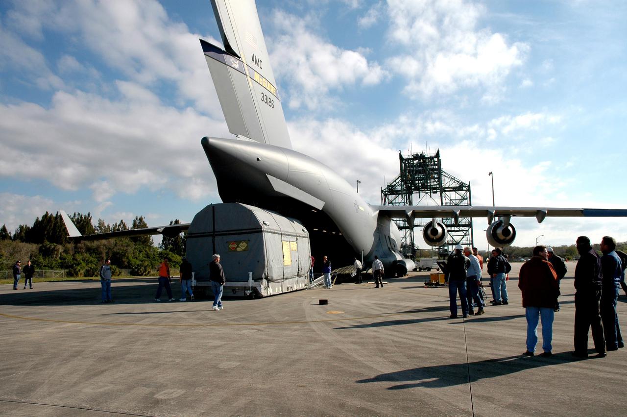 KENNEDY SPACE CENTER, FLA. - At KSC’s Shuttle Landing Facility, the latest Geostationary Operational Environmental Satellite (GOES) developed by NASA for the National Oceanic and Atmospheric Administration (NOAA) is backed away from the C17 military cargo aircraft that delivered it. Called GOES-N, the satellite is targeted to launch May 4 onboard a Boeing expendable launch vehicle Delta IV (4,2). Once in orbit GOES-N will be designated GOES-13 and will complete checkout and be placed in on-orbit storage as a replacement for an older GOES satellite. After arriving, the satellite was transported to Astrotech in Titusville, Fla., where final testing of the imaging system, instrumentation, communications and power systems will be performed over the next two months by Boeing Satellite Systems.