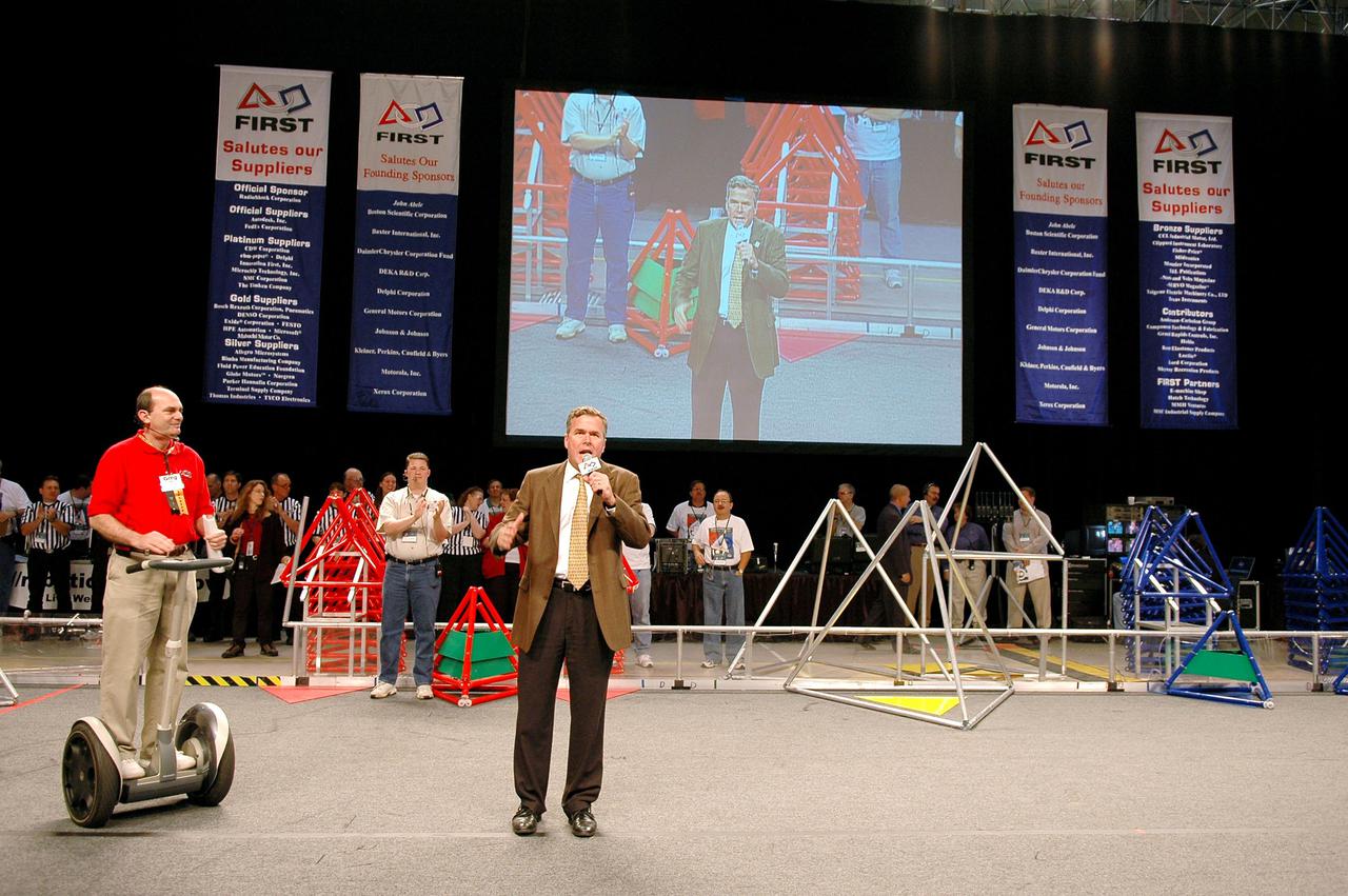 KENNEDY SPACE CENTER, FLA.  - Florida Gov. Jeb Bush (right) kicks off the 2005 FIRST Robotics Regional Competition held at the University of Central Florida March 10-12.  NASA and the University are co-hosts of the regional event. The competition stages short games played by remote-controlled robots, which are designed and built in six weeks by a team of high school students and a handful of engineers-mentors. The students control the robots on the playing field.  NASA and the University of Central Florida are co-sponsors of the regional event.  The competition stages short games played by remote-controlled robots, which are designed and built in six weeks by a team of high school students and a handful of engineers-mentors.  The students control the robots on the playing field.