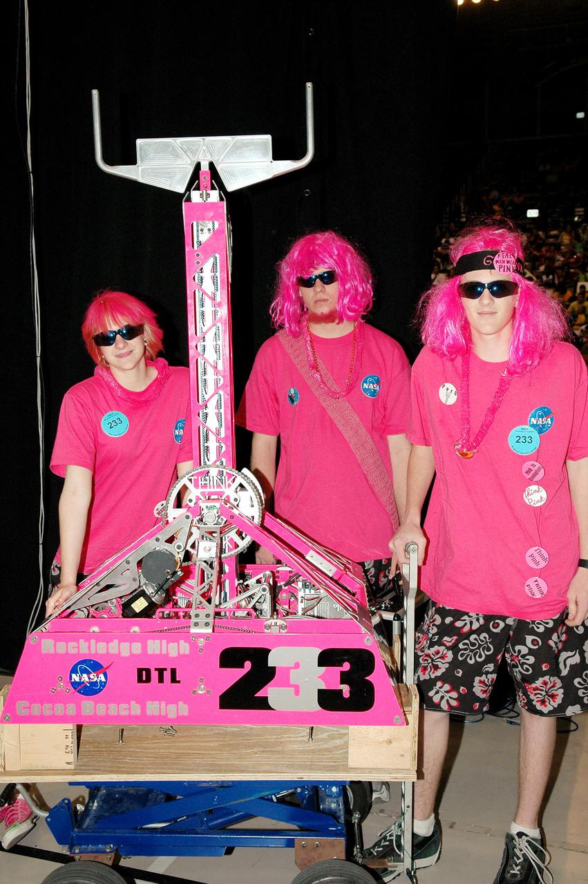 KENNEDY SPACE CENTER, FLA. - Members of the Space Coast FIRST Robotics Team, known as the Pink Team, display their robot, Roccobot, at the 2005 FIRST Robotics Regional Competition held at the University of Central Florida March 10-12. The NASA-sponsored Roccobots took first place in the competition as part of a three-team alliance and advances to the Championship in Atlanta in April. The Pink Team comprises students from Rockledge High School and Cocoa Beach Junior_Senior High School.