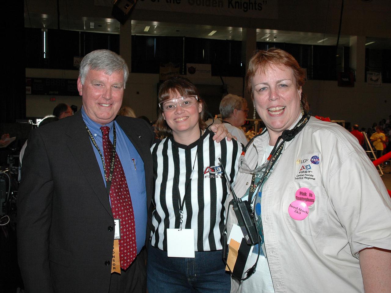KENNEDY SPACE CENTER, FLA.  - During the 2005 FIRST Robotics Regional Competition held at the University of Central Florida March 10-12, Center Director Jim Kennedy (left) greets fellow NASA employees, referee Maggi Dutczak and Laurel Lichtenberger, Planning Committee chair for the competition.  NASA and the University of Central Florida are co-hosts of the regional event. The competition stages short games played by remote-controlled robots, which are designed and built in six weeks by a team of high school students and a handful of engineers-mentors. The students control the robots on the playing field.