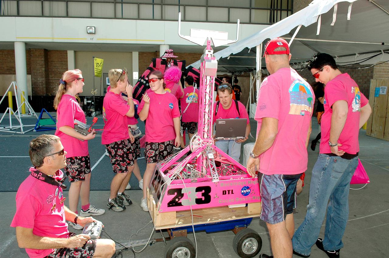 KENNEDY SPACE CENTER, FLA.  - Members of the NASA-sponsored Space Coast FIRST Robotics Team, known as the Pink Team, prepare to compete with their robot, Roccobot. The competition was part of the 2005 FIRST Robotics Regional Competition held at the University of Central Florida March 10-12, 2005.  The Pink Team took first place in the competition as part of the three-team winning alliance and advances to the Championship in Atlanta in April.  The Pink Team comprises students from Rockledge High School and Cocoa Beach Junior_Senior High School, and was joined by the Bionic Tigers from Cocoa High School, sponsored by Analex Corp., and Children of the Swamp from Inlet Grove Community High School in West Palm Beach, sponsored by UTC-Pratt and Whitney-SP.  NASA and the University of Central Florida are co-hosts of the regional event. The competition stages short games played by remote-controlled robots, which are designed and built in six weeks by a team of high school students and a handful of engineers-mentors. The students control the robots on the playing field.