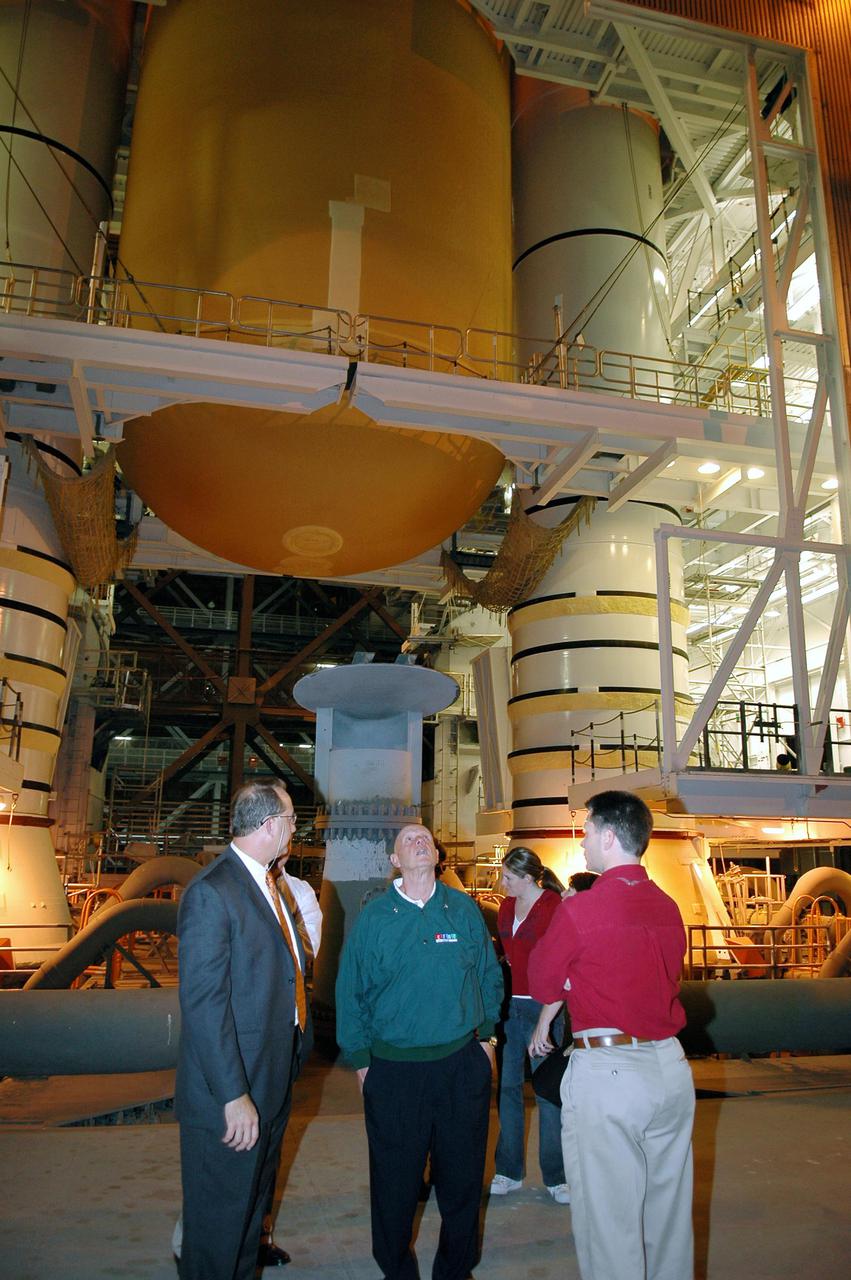 KENNEDY SPACE CENTER, FLA.  - In the Vehicle Assembly Building, author Stephen Covey (center) looks up at the External Tank_Solid Rocket Boosters stack for Return to Flight Mission STS-114.  Covey and his executive assistant Julie McAllister (at Covey’s right) are touring Kennedy.  Covey also spent time with KSC management discussing his newest book, The 8th Habit.