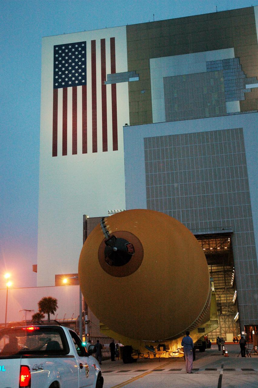 KENNEDY SPACE CENTER, FLA. - The second redesigned External Tank (ET-121) moves toward the open doors in the Vehicle Assembly Building. The tank recently arrived at the Turn Basin after its 900-mile journey at sea from the Michoud Assembly Facility in New Orleans. In addition to the Return to Flight modifications, this tank has been outfitted with temperature sensors and accelerometers, used to measure vibration. These sensors will gather information about how the tank performs during flight. The tank is designated for use on Return to Flight mission STS-121, which has a launch window of July 12 to July 31, 2005.