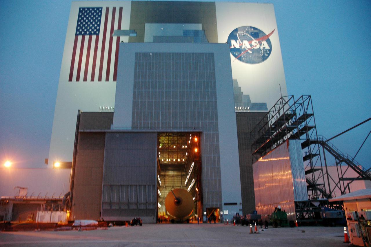 KENNEDY SPACE CENTER, FLA. - Through the open doors of the Vehicle Assembly Building can be seen the second redesigned External Tank (ET-121). The tank recently arrived at the Turn Basin after its 900-mile journey at sea from the Michoud Assembly Facility in New Orleans. In addition to the Return to Flight modifications, this tank has been outfitted with temperature sensors and accelerometers, used to measure vibration. These sensors will gather information about how the tank performs during flight. The tank is designated for use on Return to Flight mission STS-121, which has a launch window of July 12 to July 31, 2005.