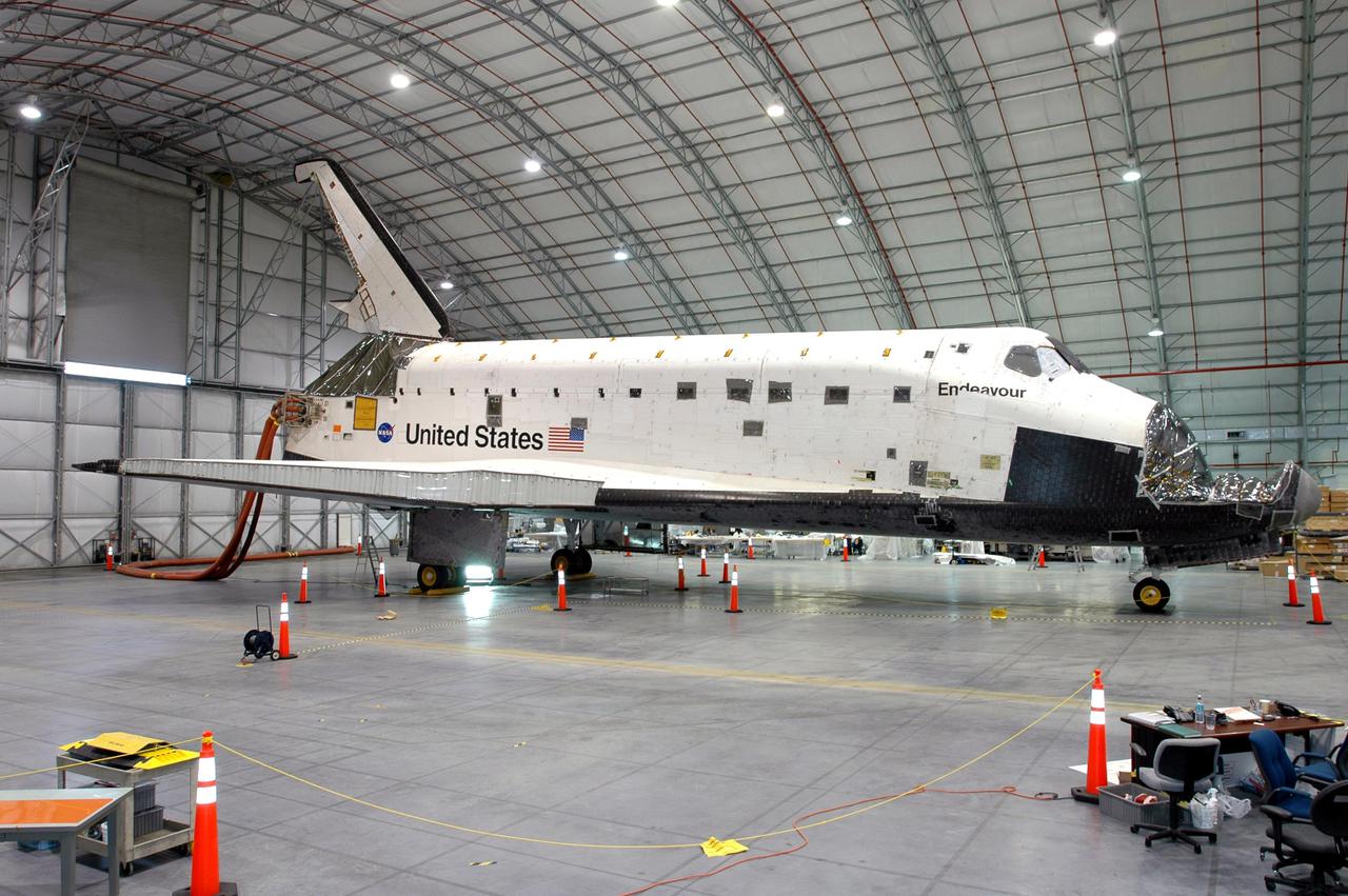 KENNEDY SPACE CENTER, FLA.  - The starboard side of orbiter Endeavour is shown as it sits inside the Florida Space Authority’s Reusable Launch Vehicle hangar at NASA’s Kennedy Space Center.   While in the hangar, Endeavour has undergone testing to see how orbiters respond to a new radar system that will be used during launch to detect debris.  Endeavour is returning to the Orbiter Processing Facility today to continue Orbiter Major Modifications (OMM).  OMMs are scheduled at regular intervals to enhance safety and performance, infuse new technology, and, in this case, perform Return to Flight modifications.