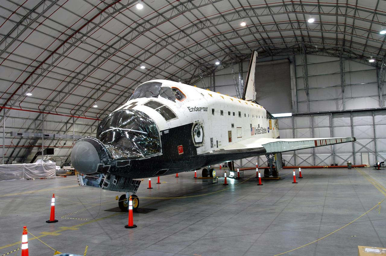 KENNEDY SPACE CENTER, FLA.  - The port side of orbiter Endeavour is shown as it sits inside the Florida Space Authority’s Reusable Launch Vehicle hangar at NASA’s Kennedy Space Center.  While in the hangar, Endeavour has undergone testing to see how orbiters respond to a new radar system that will be used during launch to detect debris.  Endeavour is returning to the Orbiter Processing Facility today to continue Orbiter Major Modifications (OMM).  OMMs are scheduled at regular intervals to enhance safety and performance, infuse new technology, and, in this case, perform Return to Flight modifications.