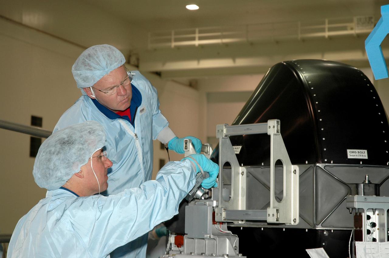 KENNEDY SPACE CENTER, FLA. - Members of the Space Shuttle Discovery’s Return to Flight STS-114 crew are conducting a payload Crew Equipment Interface Test (CEIT) in the Space Station Processing Facility at NASA’s Kennedy Space Center, Fla. Seen here are Mission Specialists Stephen Robinson (left) and Andrew Thomas. The launch window for STS-114 is May 15 to June 3, 2005. During CEIT, the crew is inspecting the resupply stowage racks installed in the Italian-built Multi-Purpose Logistics Module Raffaello and performing tool and equipment interface checks with the Thermal Protection System (TPS) repair sample box, the Control Moment Gyroscope (CMG) and the External Stowage Platform-2 in preparation for the mission’s three scheduled spacewalks. The seven-member crew will fly to the International Space Station primarily to evaluate procedures for flight safety, including Shuttle inspection and repair techniques. The TPS repair sample box contains tile samples for the Detailed Test Objective (DTO) that will enable the crew to test new on-orbit TPS repair techniques. The CMG installed on the Lightweight Multi-Purpose Experiment Support Structure Carrier (LMC) is a replacement for an inoperable CMG on the International Space Station. The CMGs provide altitude control for the outpost keeping it properly oriented toward the Sun without use of rocket fuel. The ESP2 will carry replacement parts, known as orbital replacement units (ORU) to the Station. The platform will be deployed and attached to the Station’s airlock and will be used as a permanent spare parts facility.
