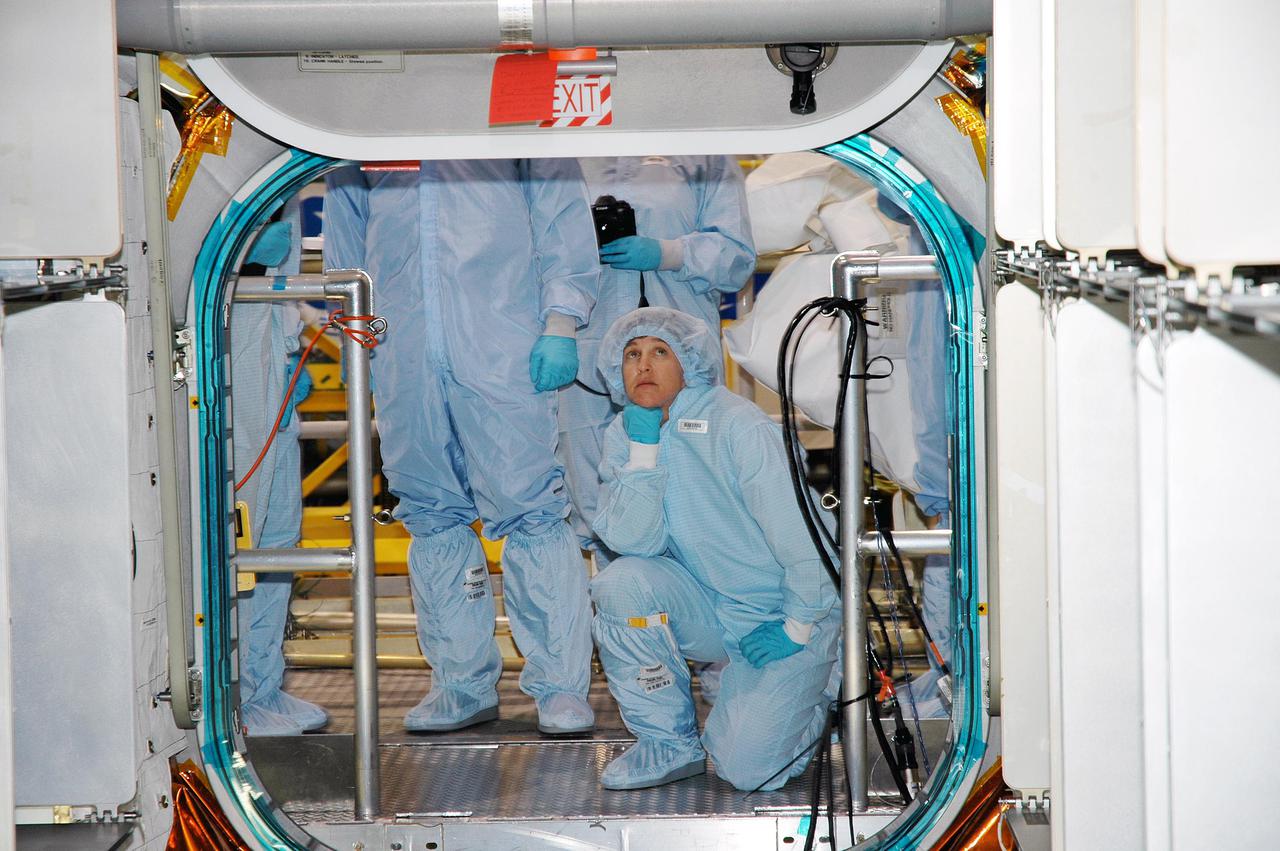 KENNEDY SPACE CENTER, FLA. - Members of the Space Shuttle Discovery’s Return to Flight STS-114 crew are conducting a payload Crew Equipment Interface Test (CEIT) in the Space Station Processing Facility at NASA’s Kennedy Space Center, Fla. Seen here in the Multi-Purpose Logistics Module Raffaello is Mission Specialist Wendy Lawrence. The launch window for STS-114 is May 15 to June 3, 2005. During CEIT, the crew is inspecting the resupply stowage racks installed in the Italian-built Multi-Purpose Logistics Module Raffaello and performing tool and equipment interface checks with the Thermal Protection System (TPS) repair sample box, the Control Moment Gyroscope (CMG) and the External Stowage Platform-2 in preparation for the mission’s three scheduled spacewalks. The seven-member crew will fly to the International Space Station primarily to evaluate procedures for flight safety, including Shuttle inspection and repair techniques. The TPS repair sample box contains tile samples for the Detailed Test Objective (DTO) that will enable the crew to test new on-orbit TPS repair techniques. The CMG installed on the Lightweight Multi-Purpose Experiment Support Structure Carrier (LMC) is a replacement for an inoperable CMG on the International Space Station. The CMGs provide altitude control for the outpost keeping it properly oriented toward the Sun without use of rocket fuel. The ESP2 will carry replacement parts, known as orbital replacement units (ORU) to the Station. The platform will be deployed and attached to the Station’s airlock and will be used as a permanent spare parts facility.