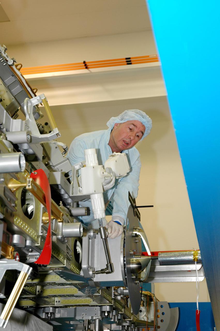 KENNEDY SPACE CENTER, FLA. - During Crew Equipment Interface Test (CEIT) at SPACEHAB in Cape Canaveral, Fla., STS-114 Mission Specialist Stephen Robinson inspects External Stowage Platform-2 (ESP2). As payload on Space Shuttle Discovery’s Return to Flight mission, the ESP2 will carry replacement parts, known as orbital replacement units (ORU) to the International Space Station. The platform will be deployed and attached to the Station’s airlock and will be used as a permanent spare parts facility. The launch window for STS-114 is May 15 to June 3, 2005. During CEIT in the Space Station Processing Facility, the crew also inspected the resupply stowage racks installed in the Italian-built Multi-Purpose Logistics Module Raffaello and performed tool and equipment interface checks with the Thermal Protection System (TPS) repair sample box, and the Control Moment Gyroscope (CMG) in preparation for the mission’s three scheduled spacewalks. The seven-member crew will fly to the Space Station primarily to evaluate procedures for flight safety, including Shuttle inspection and repair techniques.