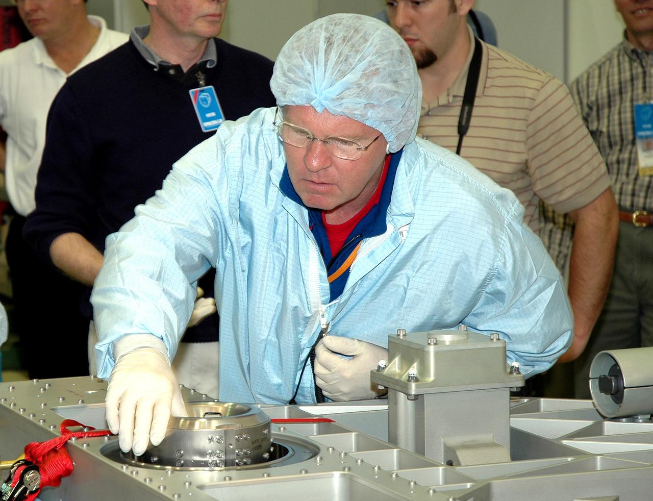 KENNEDY SPACE CENTER, FLA. - During Crew Equipment Interface Test (CEIT) at SPACEHAB in Cape Canaveral, Fla., STS-114 Mission Specialist Andrew Thomas checks out components on the External Stowage Platform-2 (ESP2). As payload on Space Shuttle Discovery’s Return to Flight mission, the ESP2 will carry replacement parts, known as orbital replacement units (ORU) to the International Space Station. The platform will be deployed and attached to the Station’s airlock and will be used as a permanent spare parts facility. The launch window for STS-114 is May 15 to June 3, 2005. Earlier, during CEIT in the Space Station Processing Facility, the crew also inspected the resupply stowage racks installed in the Italian-built Multi-Purpose Logistics Module Raffaello and performed tool and equipment interface checks with the Thermal Protection System (TPS) repair sample box, and the Control Moment Gyroscope (CMG) in preparation for the mission’s three scheduled spacewalks. The seven-member crew will fly to the Space Station primarily to evaluate procedures for flight safety, including Shuttle inspection and repair techniques.