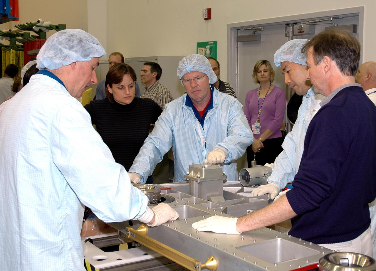 KENNEDY SPACE CENTER, FLA. - During Crew Equipment Interface Test (CEIT) at SPACEHAB in Cape Canaveral, Fla., STS-114 Mission Specialists Stephen Robinson, Soichi Noguchi and Andrew Thomas check out the External Stowage Platform-2 (ESP2). Noguchi is with the Japanese Aerospace Exploration Agency. As payload on Space Shuttle Discovery’s Return to Flight mission, the ESP2 will carry replacement parts, known as orbital replacement units (ORU) to the International Space Station. The platform will be deployed and attached to the Station’s airlock and will be used as a permanent spare parts facility. The launch window for STS-114 is May 15 to June 3, 2005. Earlier, during CEIT in the Space Station Processing Facility, the crew also inspected the resupply stowage racks installed in the Italian-built Multi-Purpose Logistics Module Raffaello and performed tool and equipment interface checks with the Thermal Protection System (TPS) repair sample box, and the Control Moment Gyroscope (CMG) in preparation for the mission’s three scheduled spacewalks. The seven-member crew will fly to the Space Station primarily to evaluate procedures for flight safety, including Shuttle inspection and repair techniques.