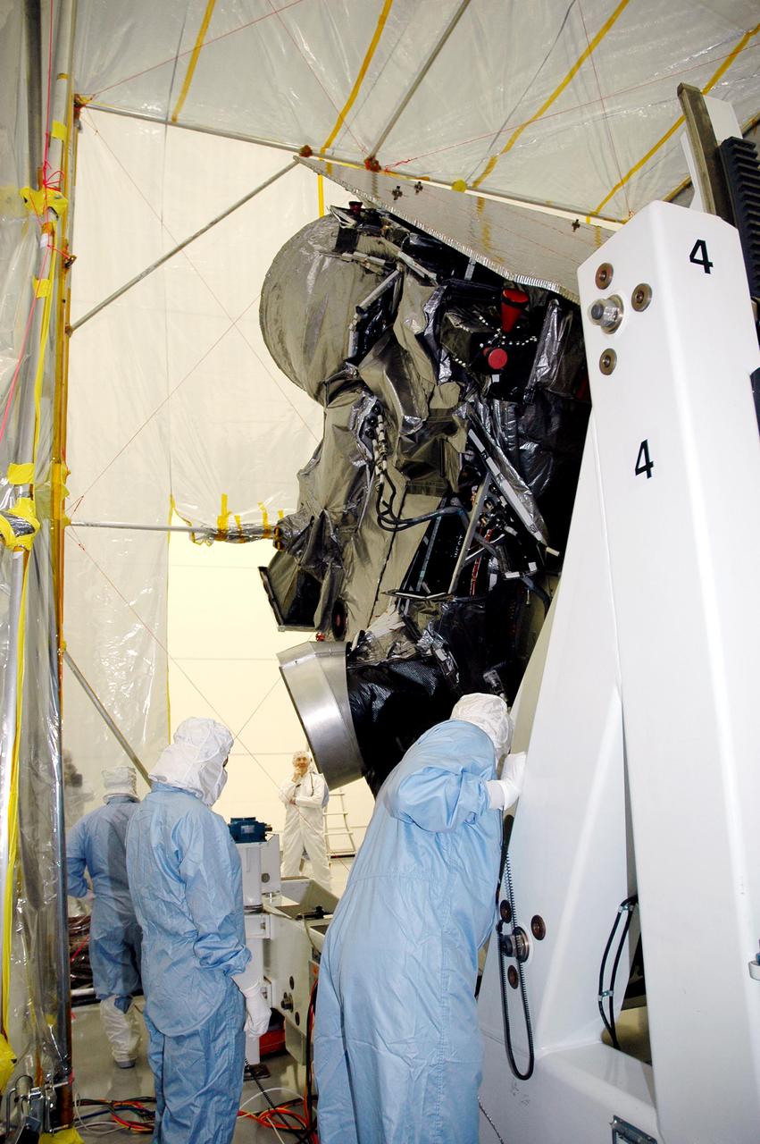 KENNEDY SPACE CENTER, FLA. - At Astrotech in Titusville, Fla., technicians closely check the progress of the rotation of the GOES-N satellite. Since its arrival on March 11, the satellite has been undergoing final testing by Boeing Satellite Systems of the imaging system, instrumentation, communications and power systems. Geostationary Operational Environmental Satellites (GOES) are sponsored by the NASA’s Goddard Space Flight Center and the National Oceanic and Atmospheric Administration. GOES-N is targeted to launch May 4 onboard a Boeing expendable launch vehicle Delta IV (4,2) with a 3-burn second stage operation. Once in orbit GOES-N will be designated GOES-13 and will complete checkout and be placed in on-orbit storage as a replacement for an older GOES satellite. GOES-N is the first in the next series of GOES satellites, N-P. The multi-mission GOES series N-P will be a vital contributor to weather, solar and space operations and science. The GOES N-P series will aid activities ranging from severe storm warnings to resource management and advances in science.