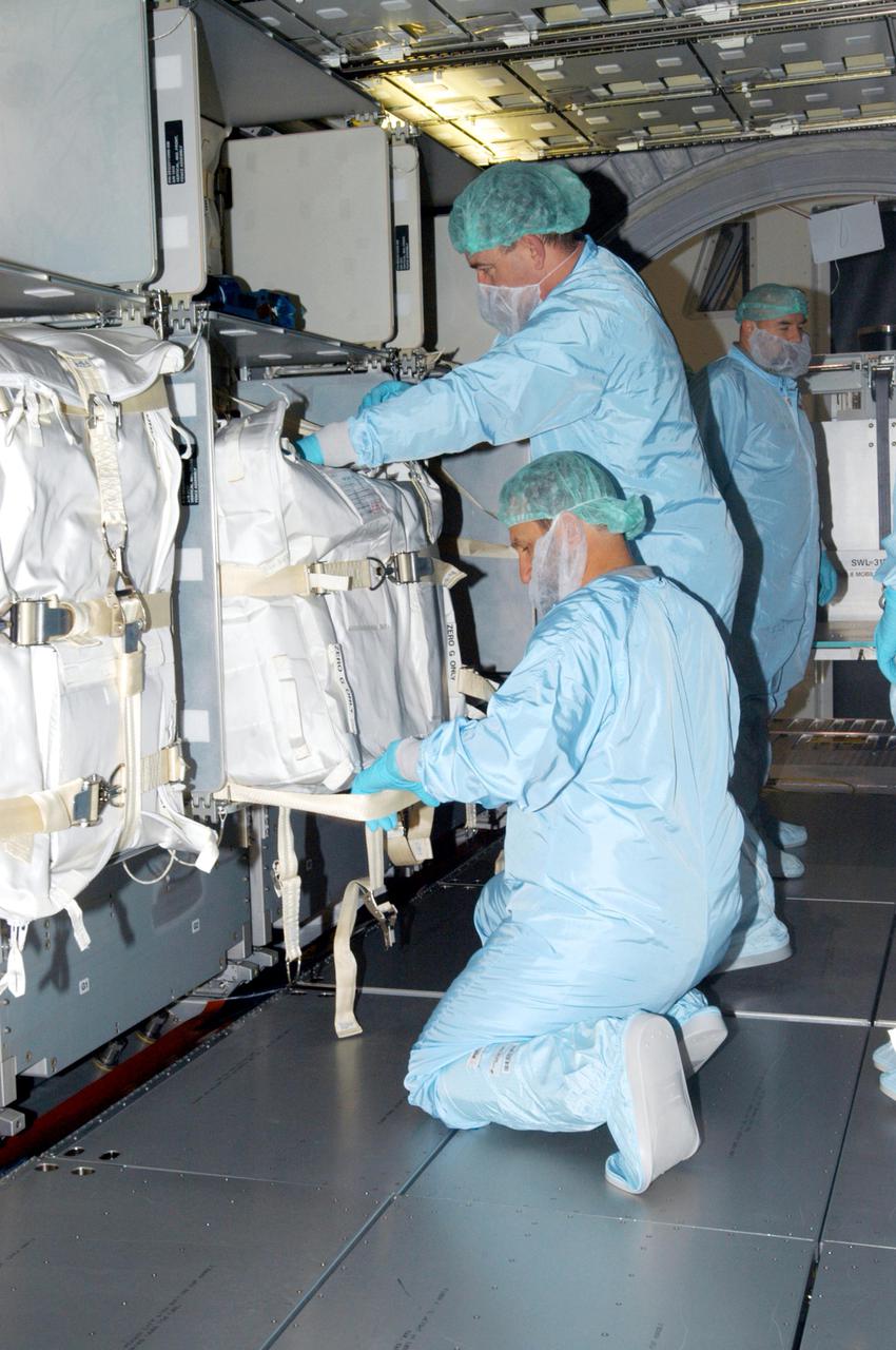 KENNEDY SPACE CENTER, FLA. - Technicians in the Space Station Processing Facility at NASA’s Kennedy Space Center place resupply stowage bags into containers known as resupply stowage racks inside the Italian-built Multi-Purpose Logistics Module Raffaello. The module will deliver a variety of supplies including food, clothing and spare parts to the International Space Station.  Raffaello will launch on Space Shuttle Discovery’s Return to Flight mission, STS-114.  The launch window is May 15 to June 3.