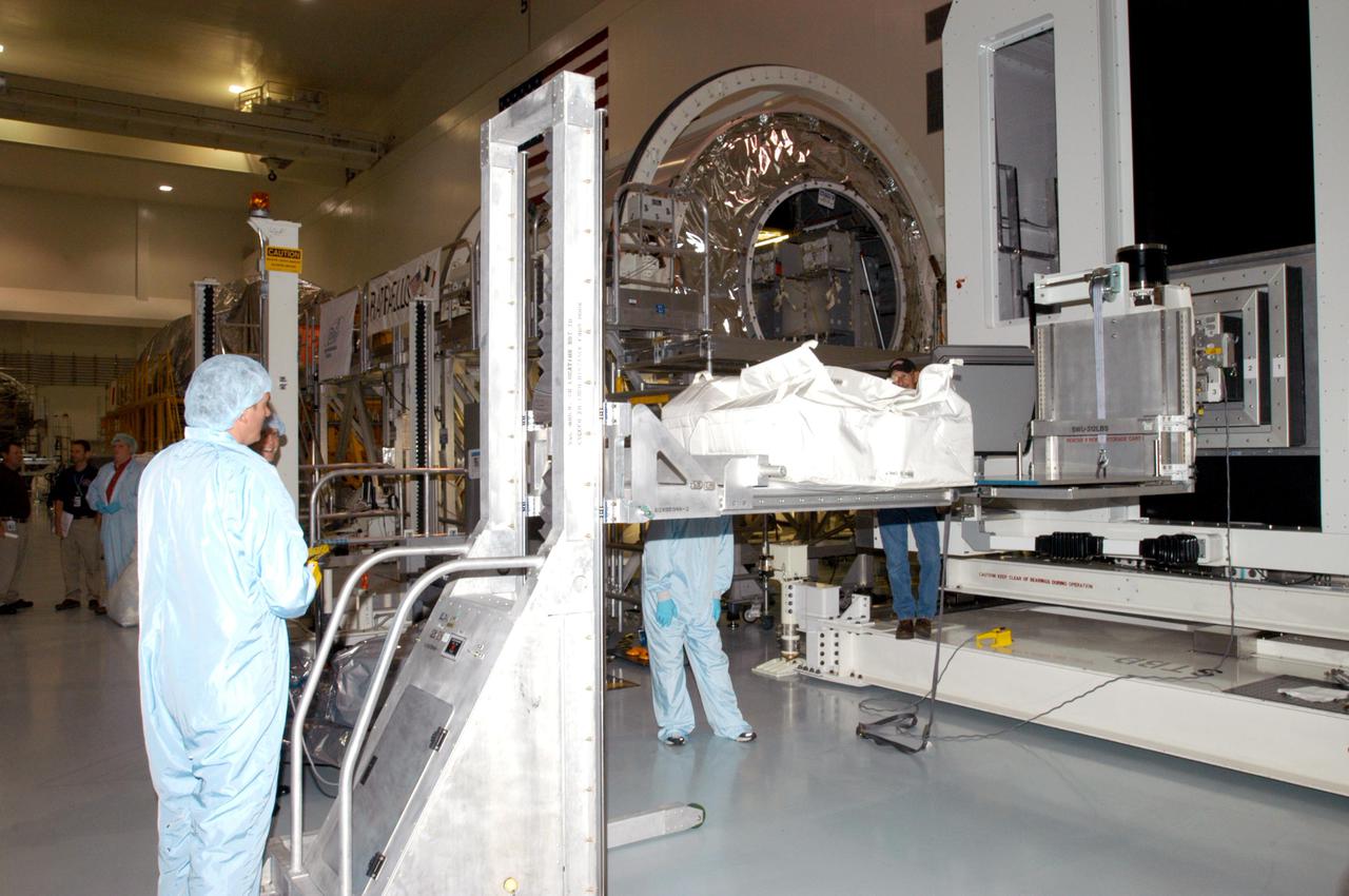 KENNEDY SPACE CENTER, FLA. - Technicians in the Space Station Processing Facility at NASA’s Kennedy Space Center get ready to move more resupply stowage bags into containers known as resupply stowage racks inside the Italian-built Multi-Purpose Logistics Module Raffaello.  The module will deliver a variety of supplies including food, clothing and spare parts to the International Space Station.  Raffaello will launch on Space Shuttle Discovery’s Return to Flight mission, STS-114.  The launch window is May 15 to June 3.
