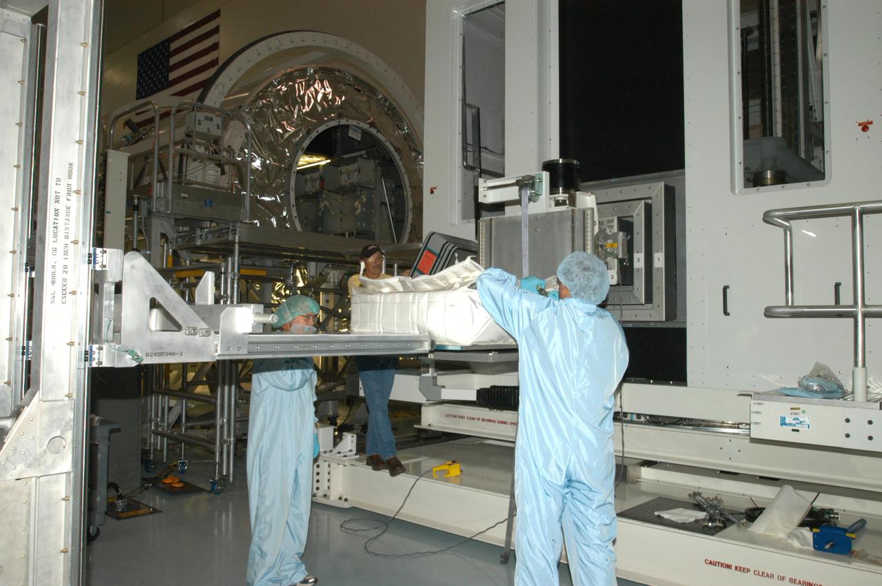 KENNEDY SPACE CENTER, FLA. - Technicians in the Space Station Processing Facility at NASA’s Kennedy Space Center finish loading resupply stowage bags to be placed in containers known as resupply stowage racks inside the Italian-built Multi-Purpose Logistics Module Raffaello.  The module will deliver a variety of supplies including food, clothing and spare parts to the International Space Station.  Raffaello will launch on Space Shuttle Discovery’s Return to Flight mission, STS-114.  The launch window is May 15 to June 3.