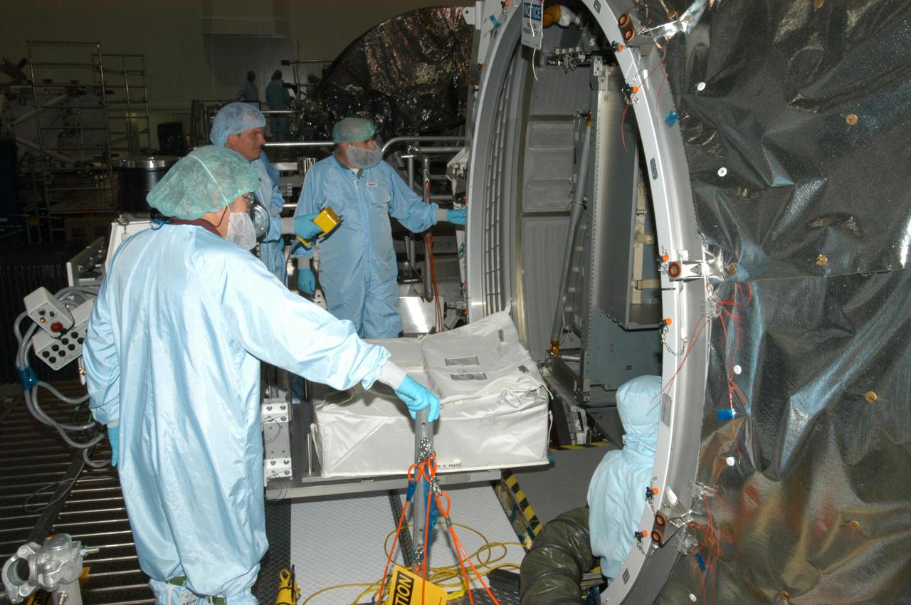KENNEDY SPACE CENTER, FLA. - Technicians in the Space Station Processing Facility at NASA’s Kennedy Space Center begin moving resupply stowage bags into the Italian-built Multi-Purpose Logistics Module Raffaello.  The bags will be placed in containers known as resupply stowage.  The module will deliver a variety of supplies including food, clothing and spare parts to the International Space Station.  Raffaello will launch on Space Shuttle Discovery’s Return to Flight mission, STS-114.  The launch window is May 15 to June 3.