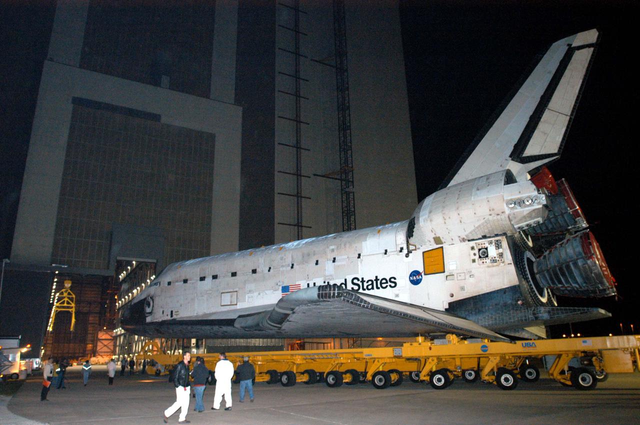 KENNEDY SPACE CENTER, FLA. - The orbiter Discovery rolls into the Vehicle Assembly Building (VAB), marking a major milestone in the march to Return to Flight. First motion was at 1:29 a.m. EST. Inside the VAB, Discovery will be mated to the External Tank_Solid Rocket Booster assembly for Return to Flight mission STS-114. After all umbilicals have been connected, workers will perform an electrical and mechanical verification of the mated interfaces to verify all critical vehicle connections. A Space Shuttle interface test is performed to verify vehicle interfaces and vehicle-to-ground interfaces. The launch processing system is used to control and monitor orbiter systems as required. Space Shuttle Discovery will roll out to Launch Pad 39B approximately one week after the rollover to the VAB. The launch window for mission STS-114 is May 15 to June 3.