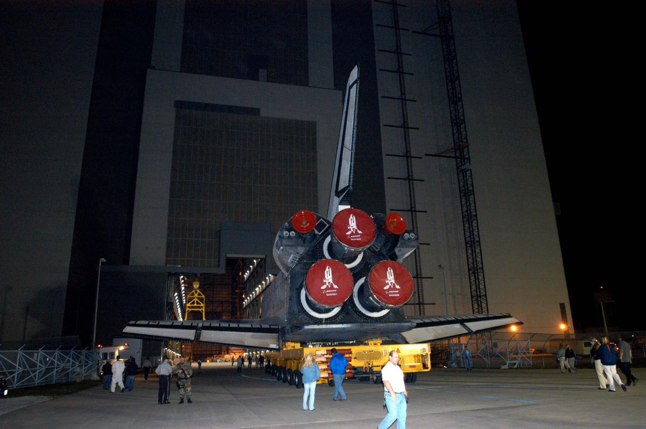 KENNEDY SPACE CENTER, FLA. - The orbiter Discovery rolls into the Vehicle Assembly Building (VAB), marking a major milestone in the march to Return to Flight. First motion was at 1:29 a.m. EST. Inside the VAB, Discovery will be mated to the External Tank_Solid Rocket Booster assembly for Return to Flight mission STS-114. After all umbilicals have been connected, workers will perform an electrical and mechanical verification of the mated interfaces to verify all critical vehicle connections. A Space Shuttle interface test is performed to verify vehicle interfaces and vehicle-to-ground interfaces. The launch processing system is used to control and monitor orbiter systems as required. Space Shuttle Discovery will roll out to Launch Pad 39B approximately one week after the rollover to the VAB. The launch window for mission STS-114 is May 15 to June 3.