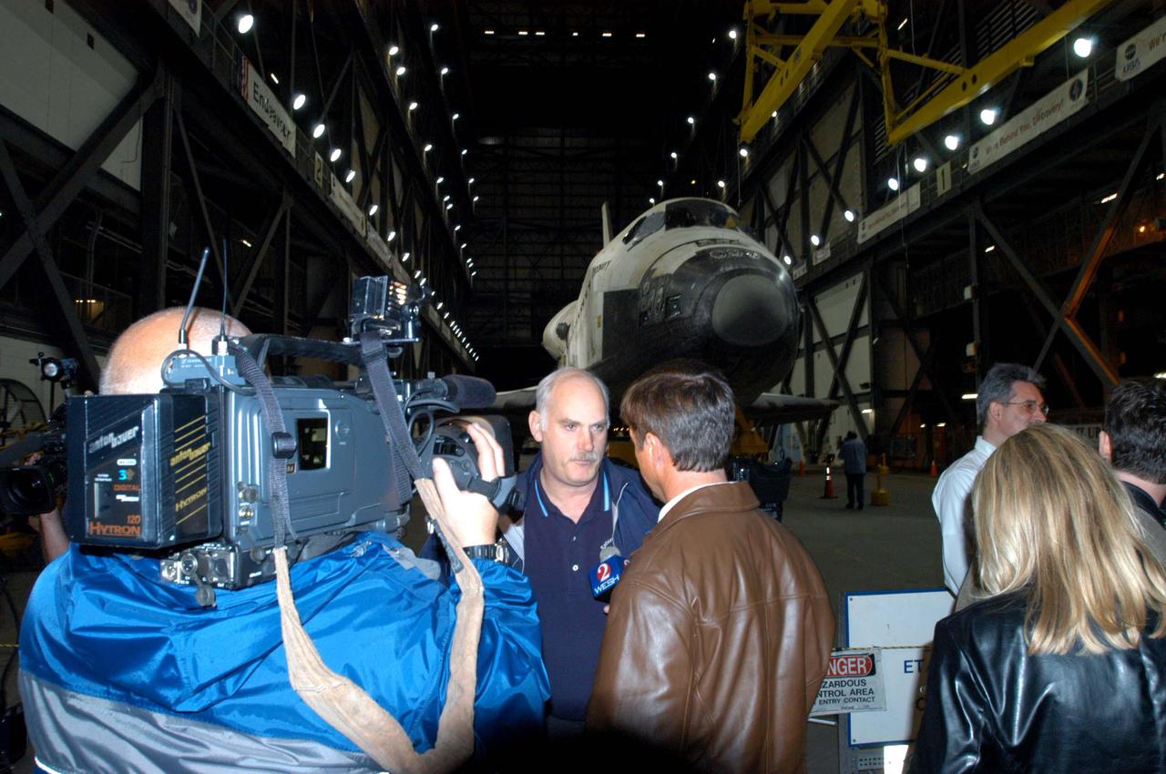 KENNEDY SPACE CENTER, FLA. - Inside the Vehicle Assembly Building, the media talk with Bill Readdy, associate administrator of NASA’s Space Operations Mission Directorate, after the orbiter Discovery’s rollover from the Orbiter Processing Facility bay 3.  The rollover marks a major milestone in the march to Return to Flight.  First motion in the OPF was at 1:29 a.m. EST.  Inside the VAB, Discovery will be mated to the External Tank_Solid Rocket Booster assembly for Return to Flight mission STS-114.  After all umbilicals have been connected, workers will perform an electrical and mechanical verification of the mated interfaces to verify all critical vehicle connections. A Space Shuttle interface test is performed to verify vehicle interfaces and vehicle-to-ground interfaces. The launch processing system is used to control and monitor orbiter systems as required.  Space Shuttle Discovery will roll out to Launch Pad 39B approximately one week after the rollover to the VAB.  The launch window for mission STS-114 is May 15 to June 3.