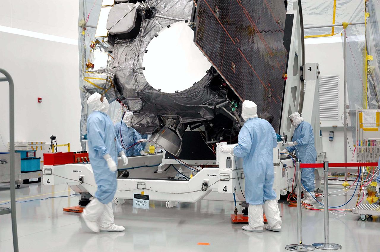 KENNEDY SPACE CENTER, FLA. - At Astrotech in Titusville, Fla., Boeing technicians observe the GOES-N satellite as it begins rotation to a vertical position. Seen on the right side is the solar panel. Since its arrival on March 11, the satellite has been undergoing final testing by Boeing Satellite Systems of the imaging system, instrumentation, communications and power systems. Geostationary Operational Environmental Satellites (GOES) are sponsored by NASA’s Goddard Space Flight Center and the National Oceanic and Atmospheric Administration. GOES-N is targeted to launch May 4 onboard a Boeing expendable launch vehicle Delta IV (4,2) with a 3-burn second stage operation.