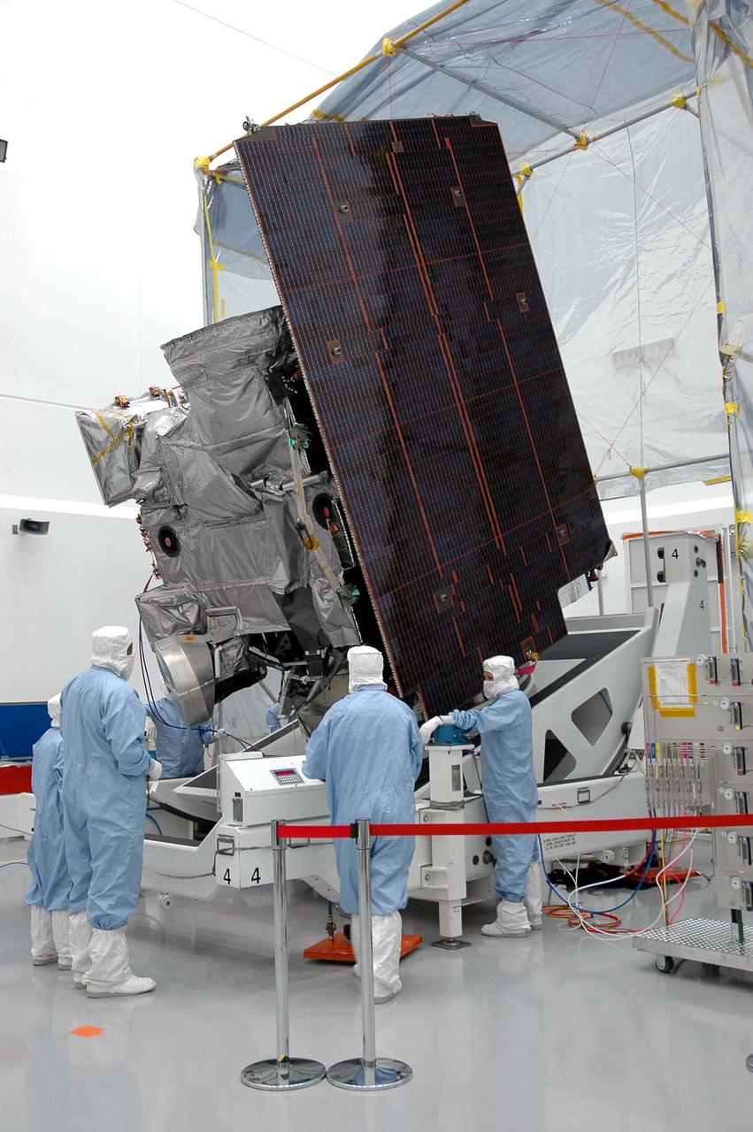 KENNEDY SPACE CENTER, FLA. - At Astrotech in Titusville, Fla., Boeing technicians check the progress of the GOES-N satellite as it rotates to a vertical position. Seen on the right side is the solar panel. Since its arrival on March 11, the satellite has been undergoing final testing by Boeing Satellite Systems of the imaging system, instrumentation, communications and power systems. Geostationary Operational Environmental Satellites (GOES) are sponsored by NASA’s Goddard Space Flight Center and the National Oceanic and Atmospheric Administration. GOES-N is targeted to launch May 4 onboard a Boeing expendable launch vehicle Delta IV (4,2) with a 3-burn second stage operation.