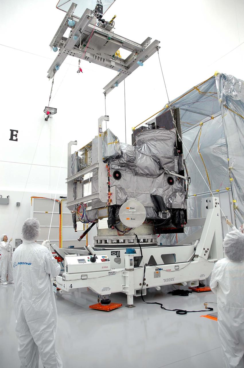 KENNEDY SPACE CENTER, FLA. - At Astrotech in Titusville, Fla., an overhead crane is moved into place above the GOES-N satellite, which is on a rotation stand.  The crane will lift the satellite from the rotation stand and move it to a work stand.  Since its arrival on March 11, the satellite has been undergoing final testing by Boeing Satellite Systems of the imaging system, instrumentation, communications and power systems. Geostationary Operational Environmental Satellites (GOES) are sponsored by NASA’s Goddard Space Flight Center and the National Oceanic and Atmospheric Administration. GOES-N is targeted to launch May 4 onboard a Boeing expendable launch vehicle Delta IV (4,2) with a 3-burn second stage operation.