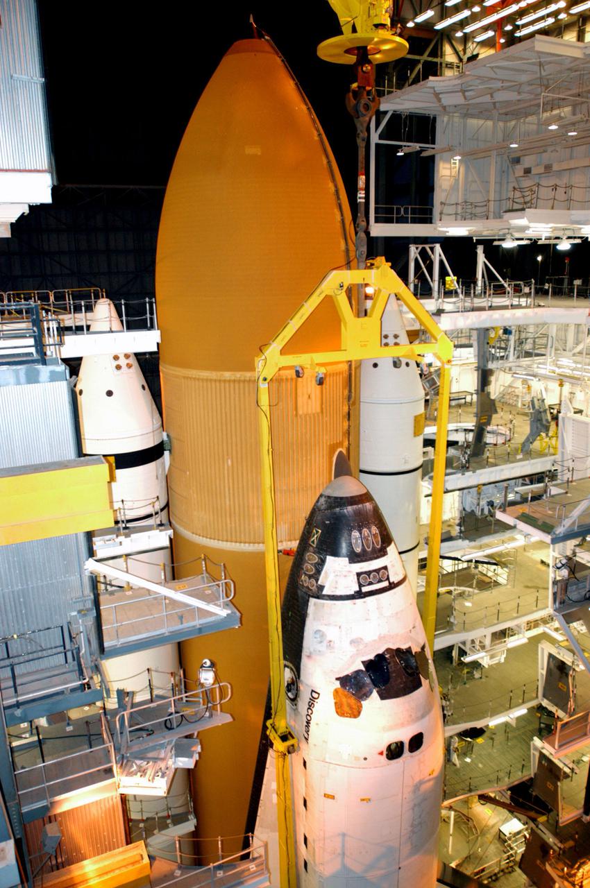 KENNEDY SPACE CENTER, FLA. - Inside the Vehicle Assembly Building at NASA’s Kennedy Space Center, the orbiter Discovery has been lowered onto the Mobile Launcher Platform (MLP) alongside the Solid Rocket Booster and External Tank stack. After Discovery has been mated to the External Tank_Solid Rocket Booster assembly on the MLP and all umbilicals have been connected, workers will perform an electrical and mechanical verification of the mated interfaces to verify all critical vehicle connections. A Shuttle interface test is performed using the launch processing system to verify Space Shuttle vehicle interfaces and Space Shuttle vehicle-to-ground interfaces. In approximately one week, Space Shuttle Discovery will be ready for rollout to Launch Pad 39B for Return to Flight mission STS-114. The launch window for STS-114 is May 15 to June 3.