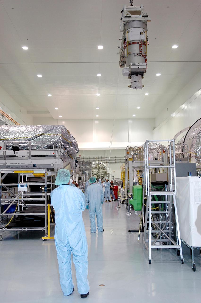 KENNEDY SPACE CENTER, FLA. - In the Space Station Processing Facility, the lower deck solar array wing scheduled to launch on International Space Station mission 12A, STS-115, is moved via an overhead crane to a work stand. The solar array is being removed in preparation for replacement of aging flight batteries. The currently installed batteries have an expected on-orbit lifetime of approximately four years. New batteries are being installed to ensure that the batteries do not exceed their lifetime expectancy prior to their planned logistics resupply on-orbit. The new batteries will have a lifetime expectancy of approximately 7 years.