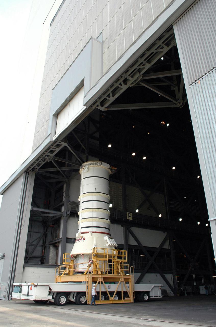 KENNEDY SPACE CENTER, FLA. - The aft segment of a Solid Rocket Booster rolls into the Vehicle Assembly Building. The segment will be mated with other segments for use on the launch of Space Shuttle Atlantis on the second Return to Flight mission, STS-121. SRBs are used as matched pairs and each is made up of four solid rocket motor segments. Two SRBs provide the main thrust to lift the Space Shuttle off the pad to an altitude of about 150,000 feet. In addition, the two SRBs carry the entire weight of the External Tank and orbiter and transmit the weight load through their structure to the Mobile Launcher Platform. Each booster has a thrust (sea level) of approximately 3,300,000 pounds at launch, and provide 71.4 percent of the thrust at liftoff and during first-stage ascent.