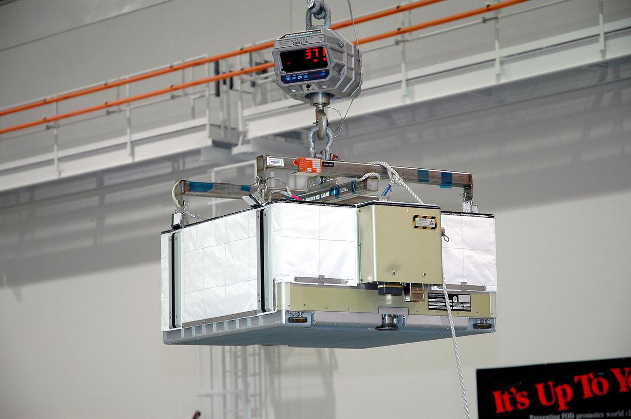 KENNEDY SPACE CENTER, FLA. - In the Space Station Processing Facility at NASA’s Kennedy Space Center, an overhead crane moves one of six batteries for the P4 truss in order to replace them. A new battery is being installed on the truss to ensure it does not exceed the lifetime expectancy prior to installation on the International Space Station. The P4 truss is part of the payload for mission 12A, STS-115.