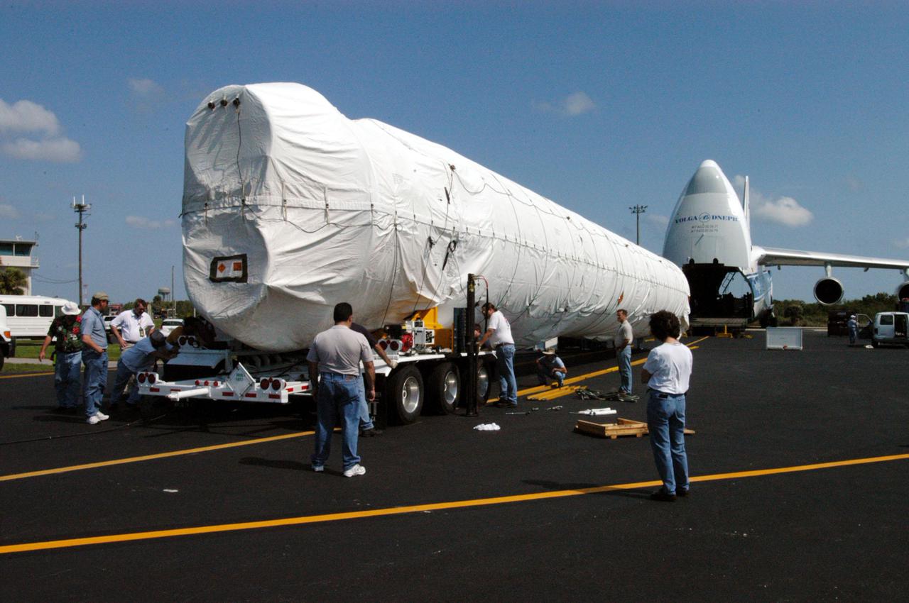 KENNEDY SPACE CENTER, FLA. - At the Cape Canaveral Air Force Station Skid Strip, workers prepare the transporter for the Lockheed Martin Atlas V booster segment for the journey to Atlas Space Operations Center. . The Atlas V, designated AV-007, is the launch vehicle for the Mars Reconnaissance Orbiter (MRO). The MRO is designed for a series of global mapping, regional survey and targeted observations from a near-polar, low-altitude Mars orbit. These observations will be unprecedented in terms of the spatial resolution and coverage achieved by the orbiter’s instruments as they observe the atmosphere and surface of Mars while probing its shallow subsurface as part of a “follow the water” strategy. The orbiter is undergoing environmental tests in facilities at Lockheed Martin Space Systems in Denver, Colo., and is on schedule for a launch window that begins Aug. 10. Launch will be from Launch Pad 41 at Cape Canaveral Air Force Station in Florida.