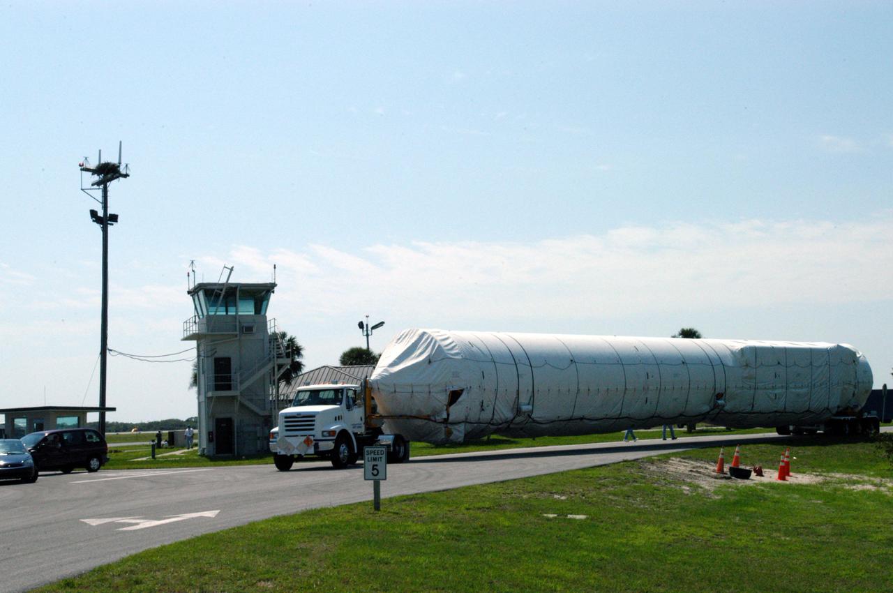KENNEDY SPACE CENTER, FLA. - The Lockheed Martin Atlas V booster segment is transported from the Cape Canaveral Air Force Station Skid Strip to Atlas Space Operations Center. The Atlas V, designated AV-007, is the launch vehicle for the Mars Reconnaissance Orbiter (MRO). The MRO is designed for a series of global mapping, regional survey and targeted observations from a near-polar, low-altitude Mars orbit. These observations will be unprecedented in terms of the spatial resolution and coverage achieved by the orbiter’s instruments as they observe the atmosphere and surface of Mars while probing its shallow subsurface as part of a “follow the water” strategy. The orbiter is undergoing environmental tests in facilities at Lockheed Martin Space Systems in Denver, Colo., and is on schedule for a launch window that begins Aug. 10. Launch will be from Launch Pad 41 at Cape Canaveral Air Force Station in Florida.
