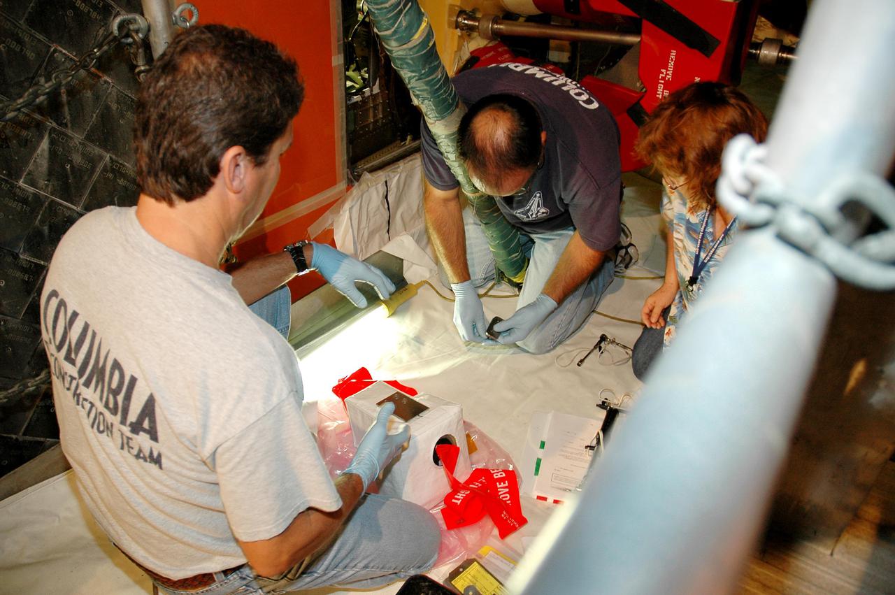 KENNEDY SPACE CENTER, FLA. - In the Vehicle Assembly Building at NASA’s Kennedy Space Center, workers prepare a  digital still camera they will mount in the External Tank (ET) umbilical well on the aft end of Space Shuttle Discovery.   The camera is being used to obtain and downlink high-resolution images of the disconnect point on the ET following the ET separation from the orbiter after launch. The Kodak camera will record 24 images, at one frame per 1.5 seconds, on a flash memory card. After orbital insertion, the crew will transfer the images from the memory card to a laptop computer. The files will then be downloaded through the Ku-band system to the Mission Control Center in Houston for analysis.