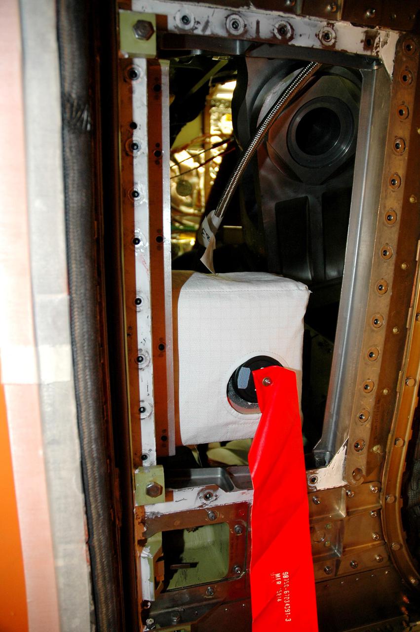 KENNEDY SPACE CENTER, FLA. - In the Vehicle Assembly Building at NASA’s Kennedy Space Center, a digital still camera has been mounted in the External Tank (ET) umbilical well on the aft end of Space Shuttle Discovery.   The camera is being used to obtain and downlink high-resolution images of the disconnect point on the ET following ET separation from the orbiter after launch. The Kodak camera will record 24 images, at one frame per 1.5 seconds, on a flash memory card. After orbital insertion, the crew will transfer the images from the memory card to a laptop computer. The files will then be downloaded through the Ku-band system to the Mission Control Center in Houston for analysis.