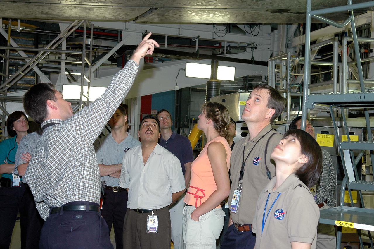 KENNEDY SPACE CENTER, FLA. - At NASA’s Kennedy Space Center, the 2004 class of astronaut candidates tour the Orbiter Processing Facility bay 1 where Atlantis (overhead) is being processed for Return to Flight mission STS-121 in July.  NASA Vehicle Manager for Atlantis, Scott Thurston talks to them about the orbiter.  The astronaut candidates are at KSC to participate in firefighting training and familiarization tours.   The class of 14 candidates includes three candidates from the Japan Aerospace Exploration Agency as well as three educator astronauts, who were school teachers chosen from thousands of applicants.