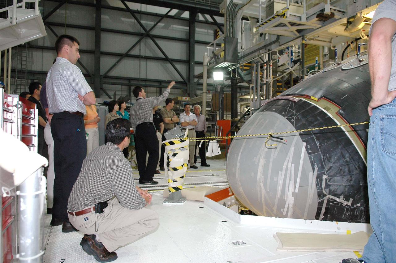 KENNEDY SPACE CENTER, FLA. - At NASA’s Kennedy Space Center, the 2004 class of astronaut candidates get a close look at the nose of Atlantis while touring the Orbiter Processing Facility bay 1.  Atlantis is being processed for Return to Flight mission STS-121 in July.  At center, in the background,  is the  NASA Vehicle Manager for Atlantis, Scott Thurston,  talking about the orbiter.    The astronaut candidates are at KSC to participate in firefighting training and familiarization tours.   The class of 14 candidates includes three candidates from the Japan Aerospace Exploration Agency as well as three educator astronauts, who were school teachers chosen from thousands of applicants.