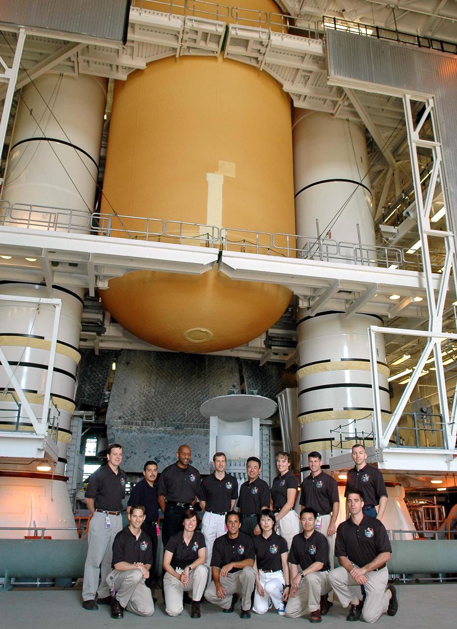KENNEDY SPACE CENTER, FLA. -  At NASA’s Kennedy Space Center, the 2004 class of astronaut candidates gather for a photo in front of Space Shuttle Discovery in the Vehicle Assembly Building.  Above them are the External Tank and twin Solid Rocket Boosters.  The ascans are, in the back row, left to right, Richard Arnold II, Jose Hernandez, Robert Satcher, Thomas Marshburn, Satoshi Furukawa, Dorothy Metcalf-Lindenburger, Robert Kimbrough and Randolph Bresnik; in the front row, left to right, are James Dutton, Shannon Walker, Joseph Acaba, Naoko Yamazaki, Akahiko Hoshide and Christopher Cassidy.   The class of 14 candidates includes three candidates from the Japan Aerospace Exploration Agency as well as three educator astronauts, who were school teachers chosen from thousands of applicants.