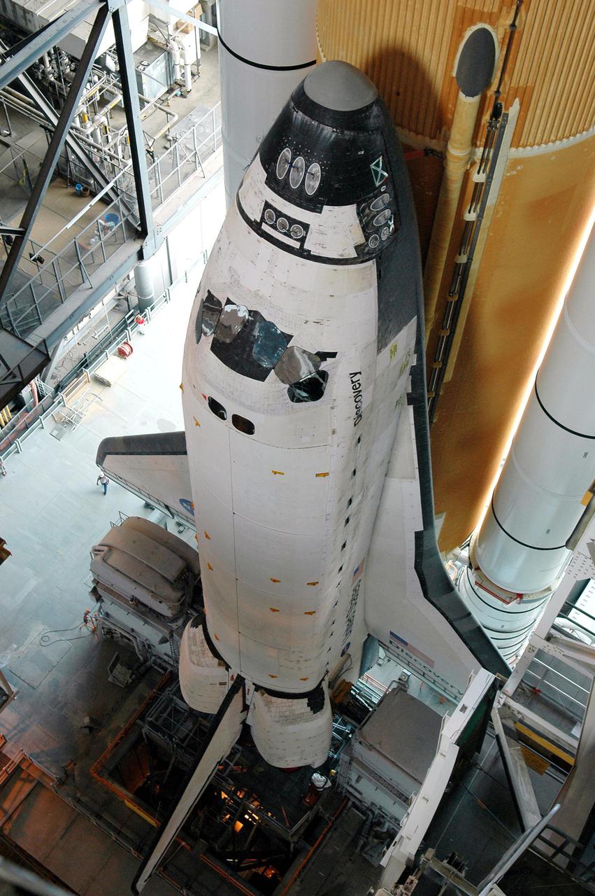 KENNEDY SPACE CENTER, FLA. -  In the Vehicle Assembly Building (VAB) at NASA’s Kennedy Space Center, Space Shuttle Discovery is beginning its long, slow journey to Launch Pad 39B.  First motion was at 2:04 p.m. EDT.  The Shuttle comprises the orbiter, External Tank (ET) and twin Solid Rocket Boosters (SRBs).  The Space Shuttle rests on the Mobile Launcher Platform, which is moved by the Crawler-Transporter underneath.  The Crawler is 20 feet high, 131 feet long and 114 feet wide.  It moves on eight tracks, each containing 57 shoes, or cleats, weighing one ton each.  Loaded with the Space Shuttle, the Crawler can move at a maximum speed of approximately 1 mile an hour. A leveling system in the Crawler keeps the Shuttle vertical while negotiating the 5 percent grade leading to the top of the launch pad.  Launch of Discovery on its Return to Flight mission, STS-114, is targeted for May 15 with a launch window that extends to June 3. During its 12-day mission, Discovery’s seven-person crew will test new hardware and techniques to improve Shuttle safety, as well as deliver supplies to the International Space Station.  Discovery was moved on March 29 from the Orbiter Processing Facility to the VAB and attached to its propulsion elements, a redesigned ET and twin SRBs.