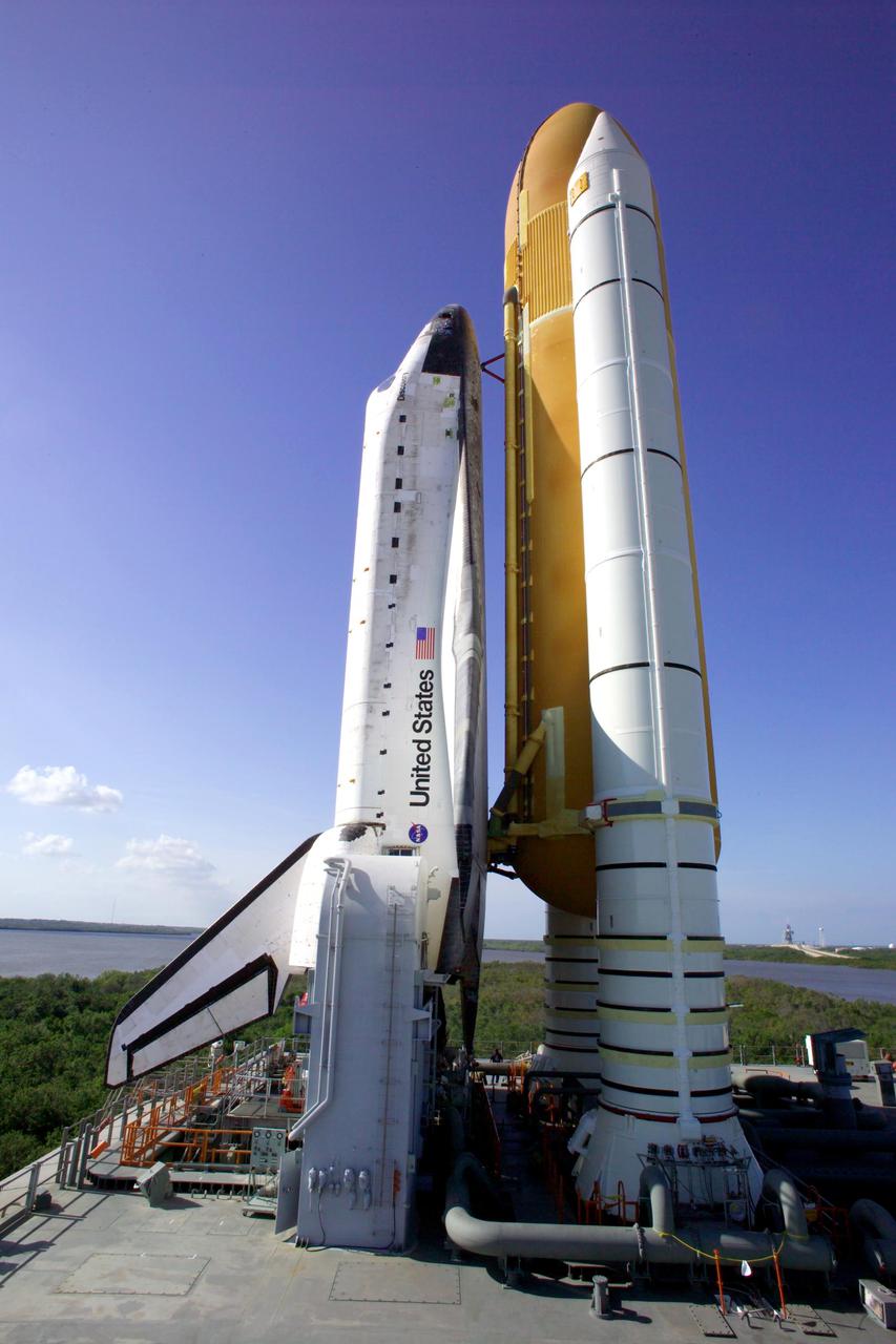 KENNEDY SPACE CENTER, FLA. -   At NASA’s Kennedy Space Center, Space Shuttle Discovery is viewed from the side as it sits atop the Mobile Launcher Platform (MLP) rolling out to Launch Complex 39B.  First motion out of the Vehicle Assembly Building occurred at 2:04 p.m. EDT.  The rollout marks a major milestone in the Space Shuttle Program’s Return to Flight. The MLP is moved by the Crawler-Transporter underneath, which stands 20 feet high, 131 feet long and 114 feet wide.  It moves on eight tracks, each containing 57 shoes, or cleats, weighing one ton each.  Loaded with the Space Shuttle, the Crawler can move at a maximum speed of approximately 1 mile an hour. A leveling system in the Crawler keeps the Shuttle vertical while negotiating the 5 percent grade leading to the top of the launch pad.  Launch of Discovery on its Return to Flight mission, STS-114, is targeted for May 15 with a launch window that extends to June 3. During its 12-day mission, Discovery’s seven-person crew will test new hardware and techniques to improve Shuttle safety, as well as deliver supplies to the International Space Station.