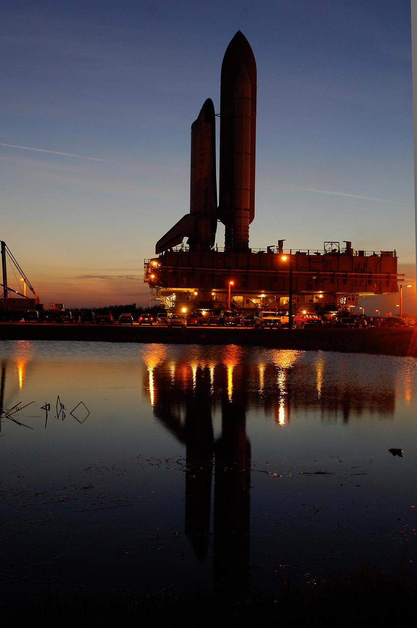 KENNEDY SPACE CENTER, FLA. - Space Shuttle Discovery lingers at the foot of Launch Pad 39B in the evening twilight. First motion from the Vehicle Assembly Building was at 2:04 p.m. EDT April 6, and the Shuttle was hard down on the pad at 1:16 a.m. EDT April 7. The Shuttle sits atop a Mobile Launcher Platform transported by a Crawler-Transporter underneath. Launch of Discovery on its Return to Flight mission, STS-114, is targeted for May 15 with a launch window that extends to June 3. During its 12-day mission, Discovery’s seven-member crew will test new hardware and techniques to improve Shuttle safety, as well as deliver supplies to the International Space Station. Photo courtesy of Scott Andrews.