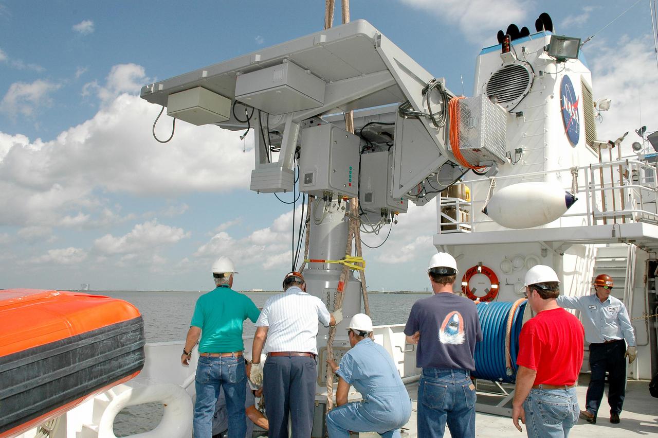 KENNEDY SPACE CENTER, FLA. - At Hangar AF at Cape Canaveral Air Force Station, workers on the Liberty Star,  one of the two SRB Retrieval Ships, oversee the safe placement of an X-band Doppler radar array onto the deck.  The radar will be used for tracking support on NASA’s Return to Flight mission, STS-114, on Space Shuttle Discovery.  Launch is targeted for May 15 with a launch window that extends to June 3. During its 12-day mission, Discovery’s seven-member crew will test new hardware and techniques to improve Shuttle safety, as well as deliver supplies to the International Space Station.